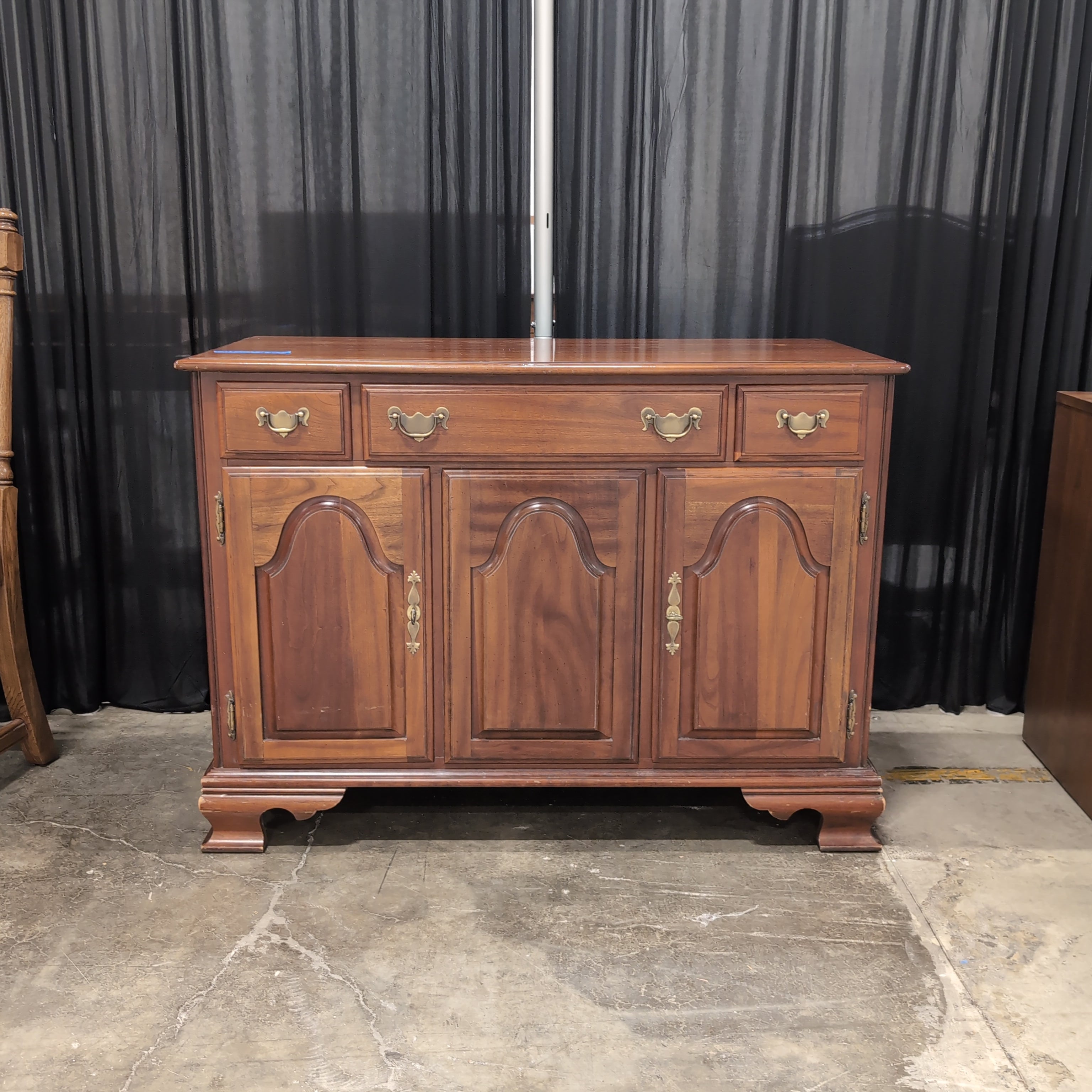 Traditional Cherry-Toned Wood Buffet with Ornate Hardware
