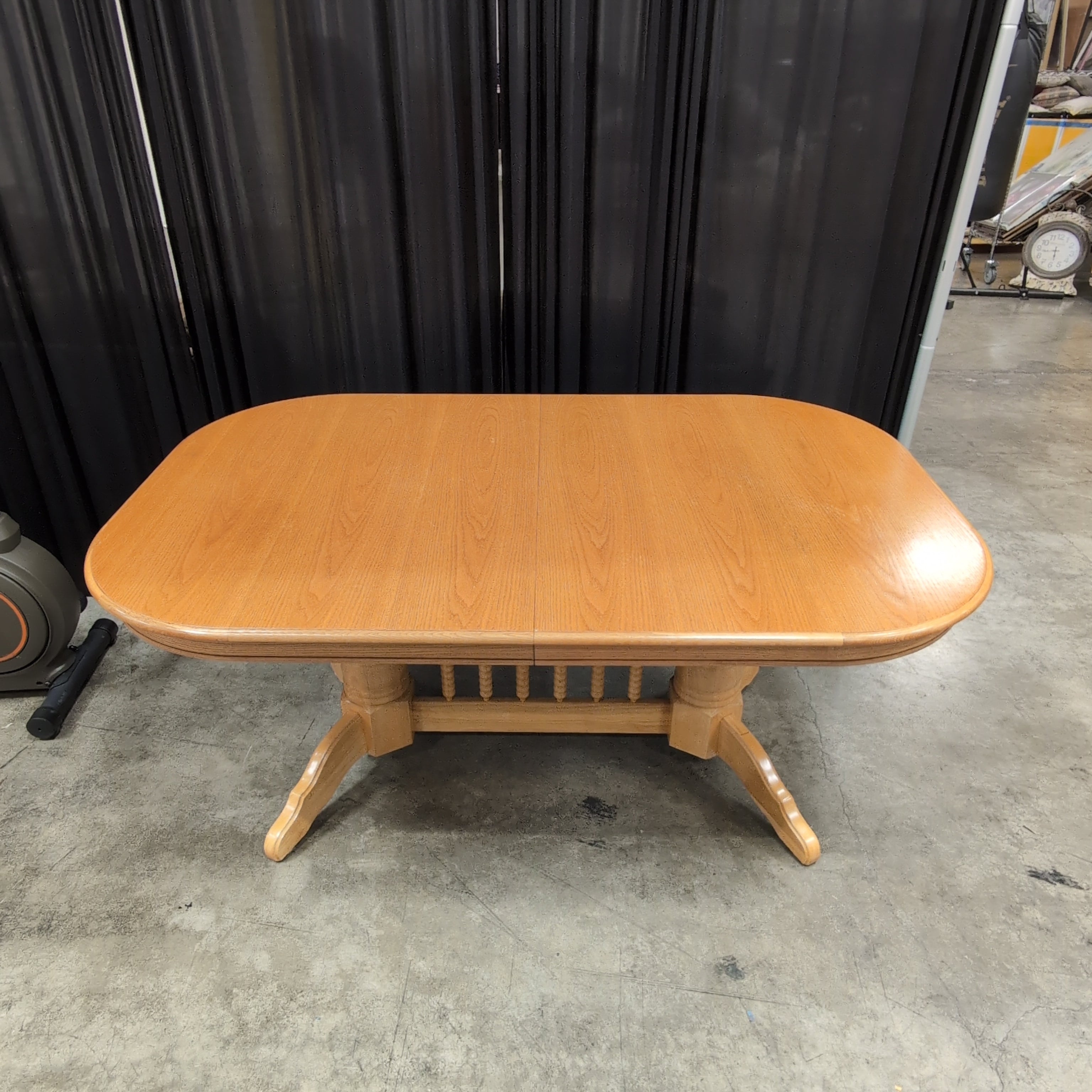 Light Wood Oval Top Dining Table with Spindle Back Chairs