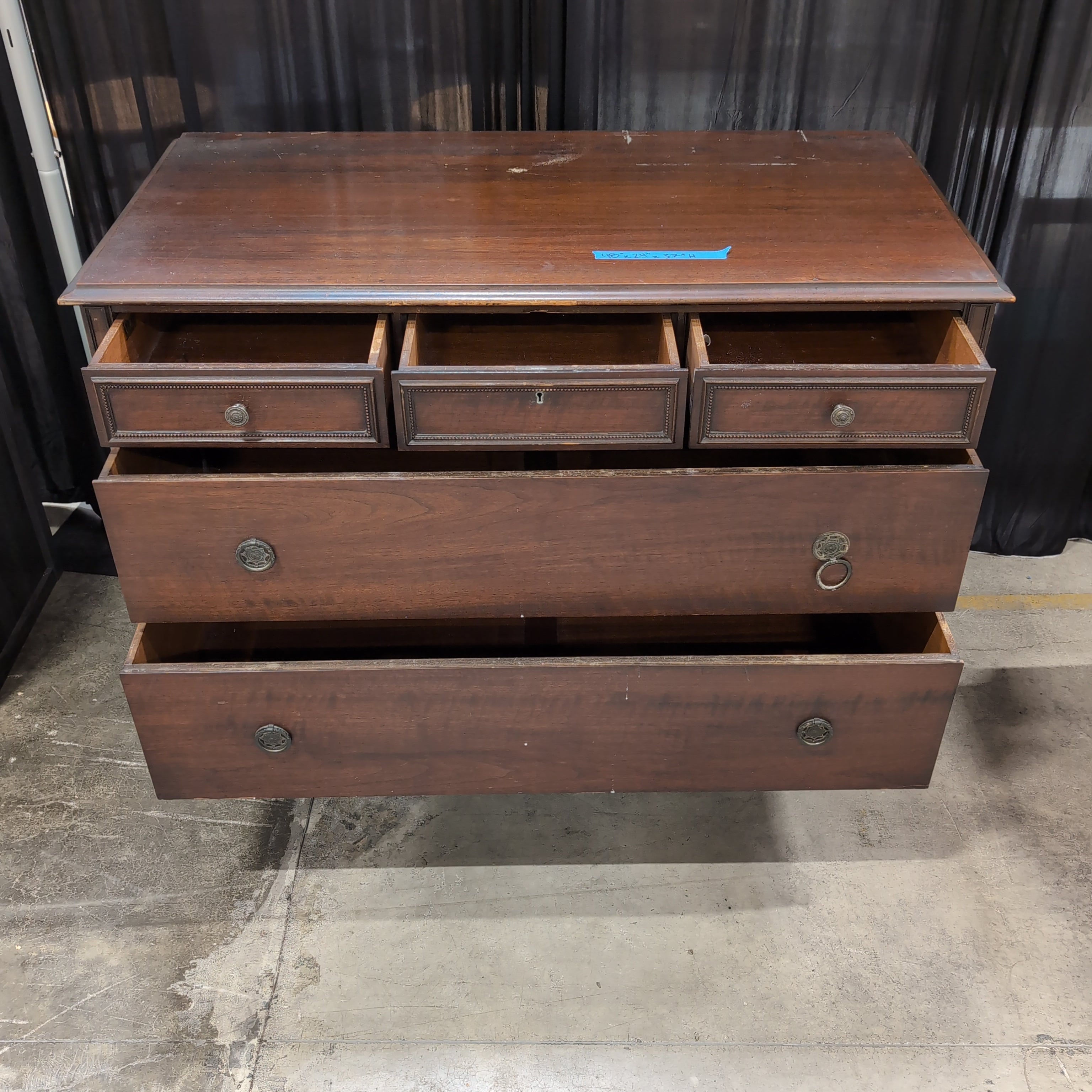 Dark Wood Three-Drawer Dresser with Recessed Panels