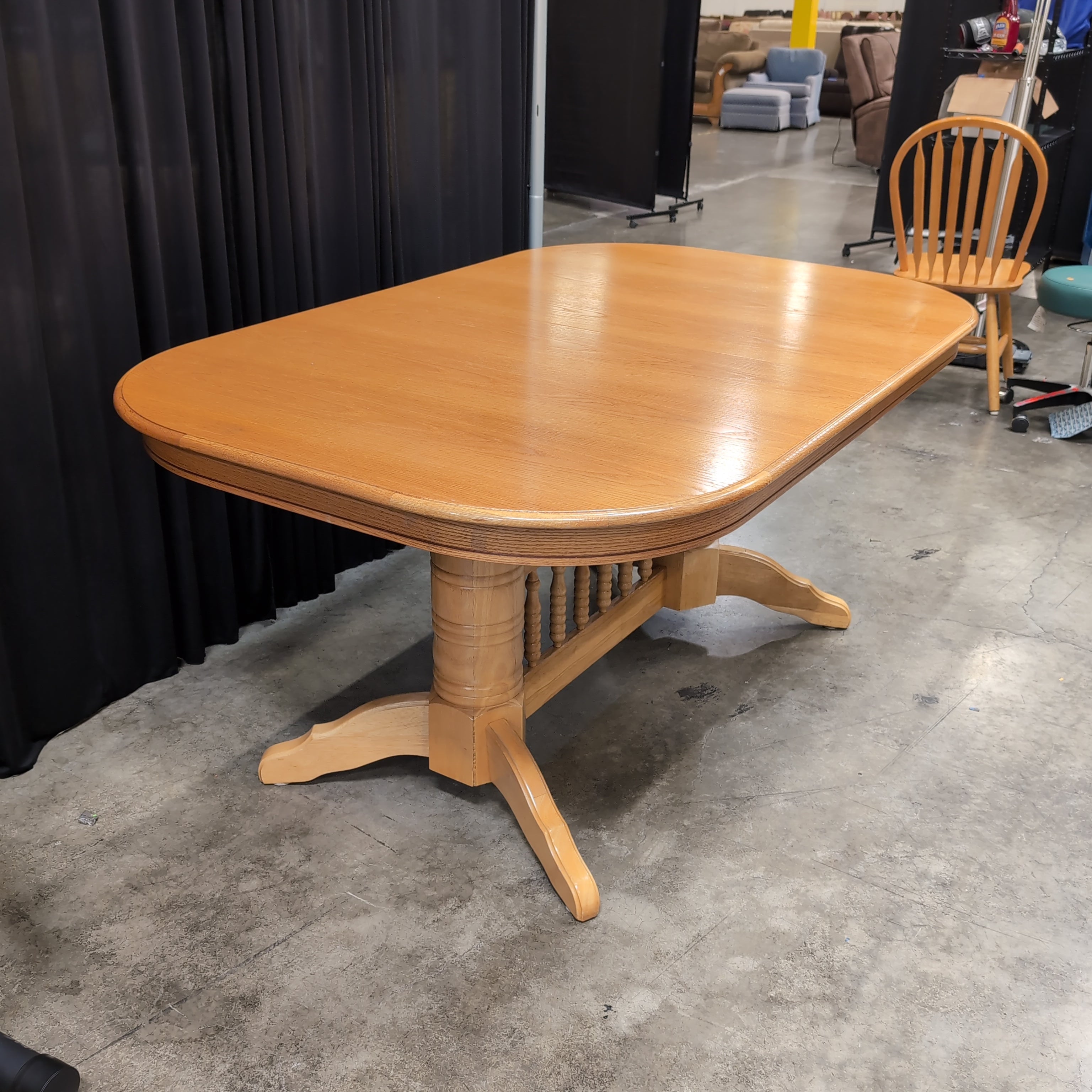 Light Wood Oval Top Dining Table with Spindle Back Chairs