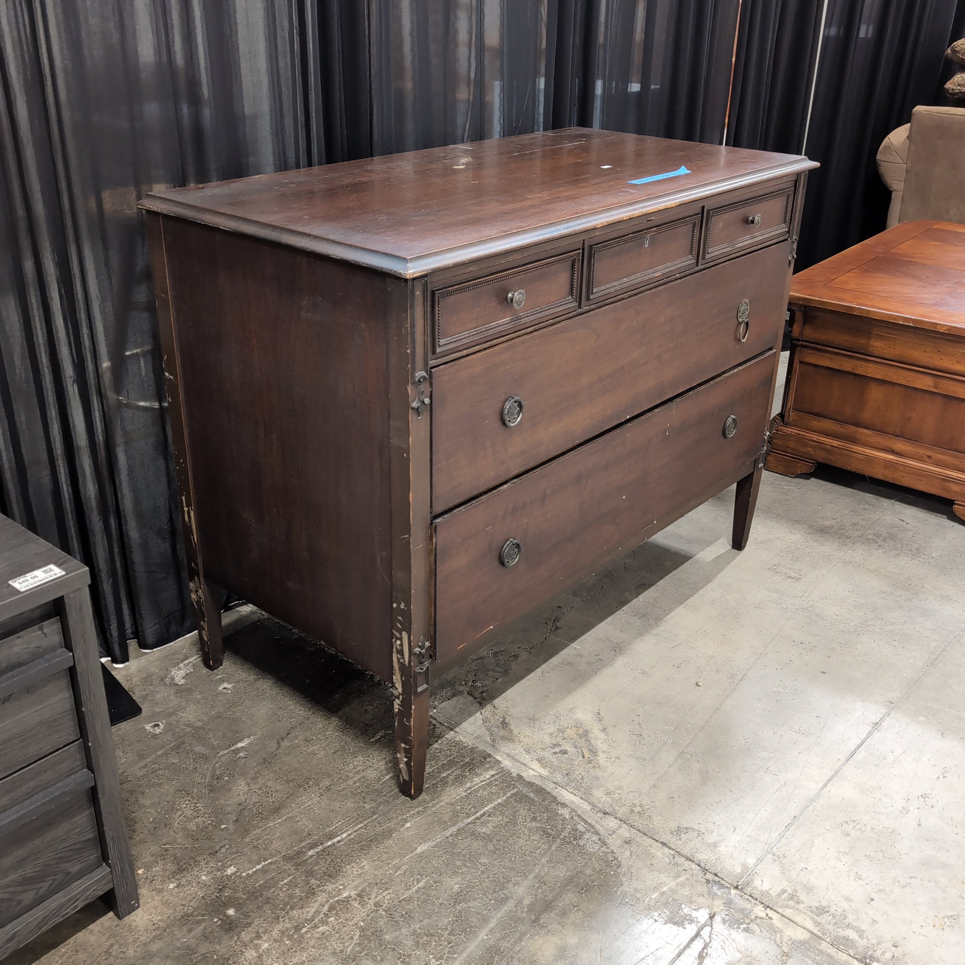 Dark Wood Three-Drawer Dresser with Recessed Panels