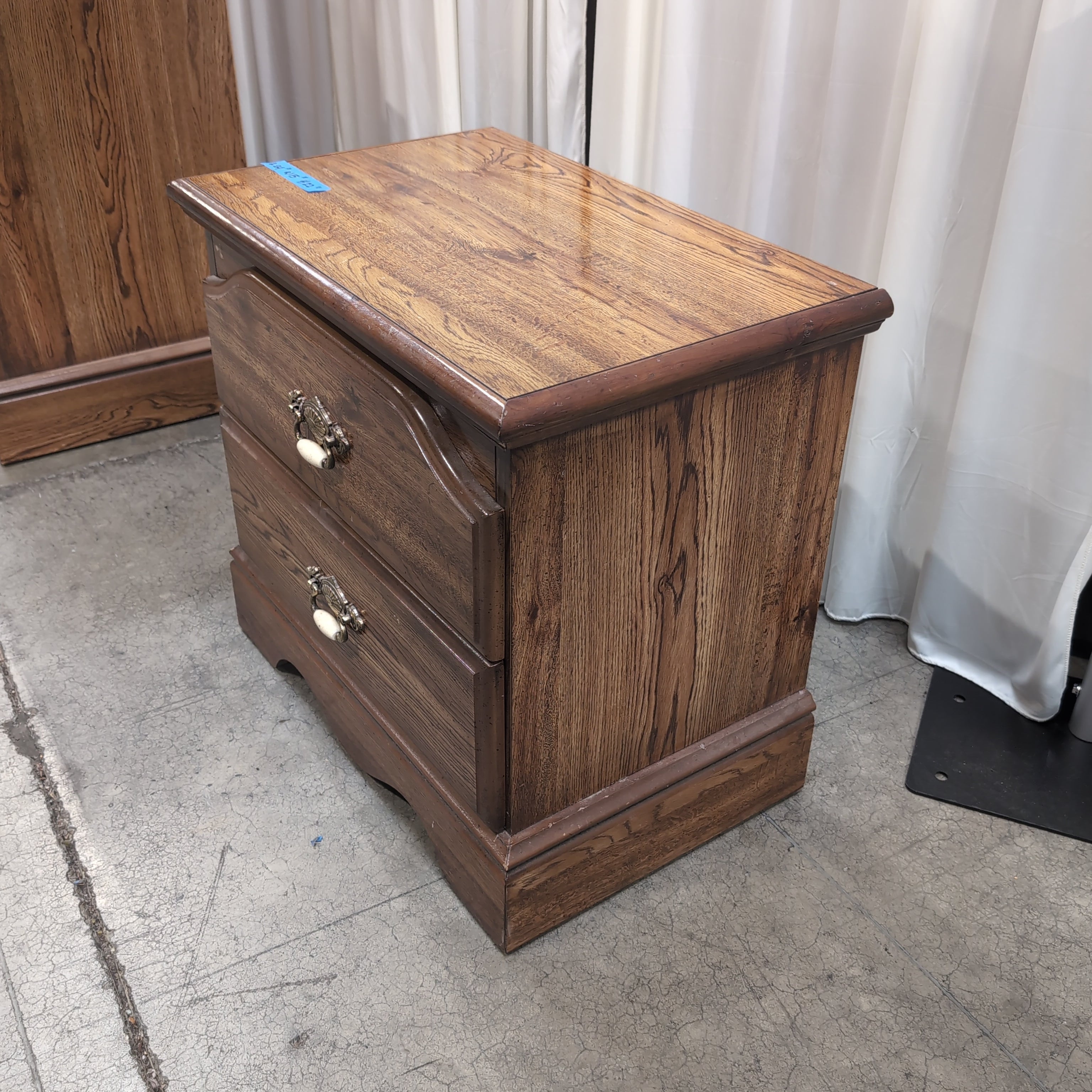 Brown Two-Drawer Wood Nightstand with Ornate Pulls