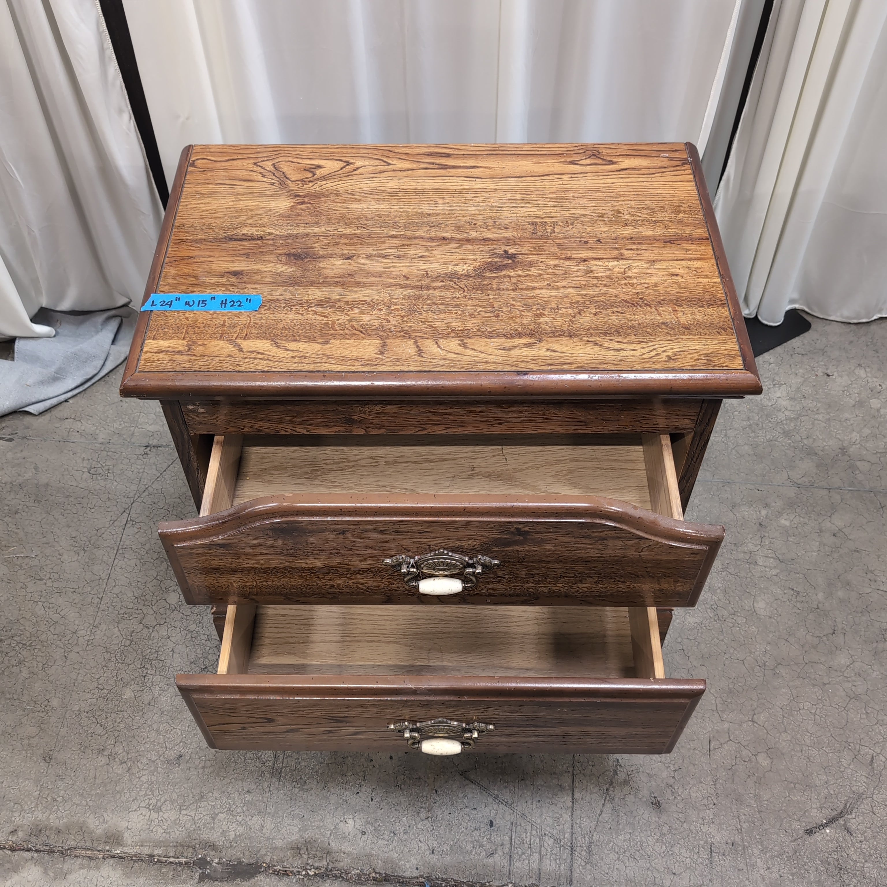 Brown Two-Drawer Wood Nightstand with Ornate Pulls