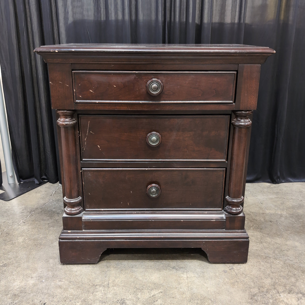 Dark Hardwood Three-Drawer Nightstand with Turned Columns