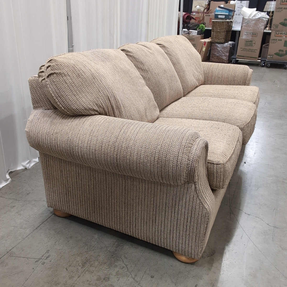Tan Textured Fabric Three-Cushion Couch with Rolled Arms