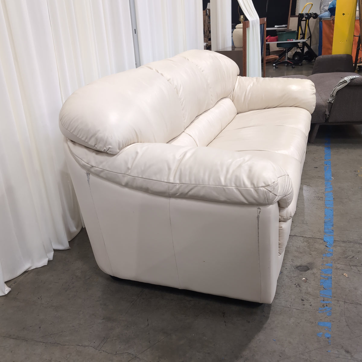 Cream-Colored Three-Seat Padded Couch