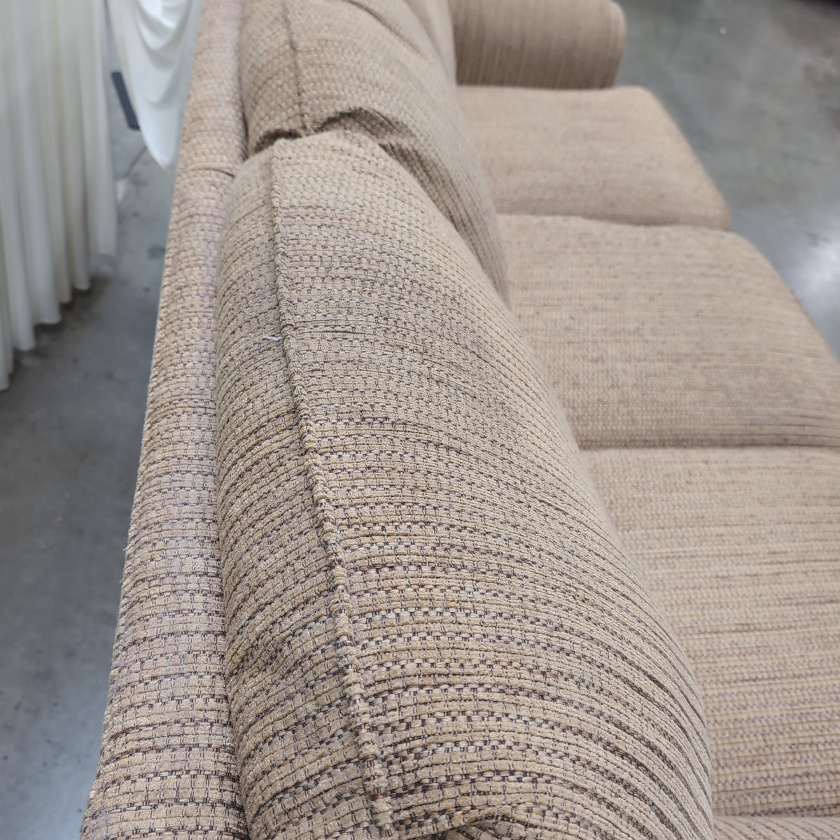 Tan Textured Fabric Three-Cushion Couch with Rolled Arms