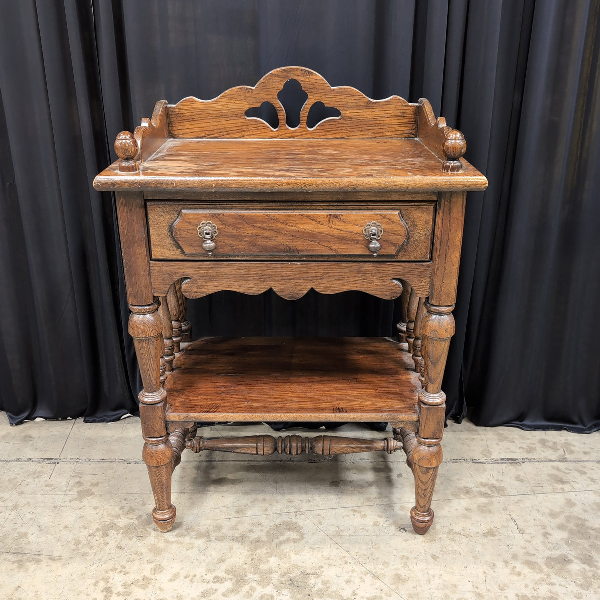 Dark Stained Wood Nightstand with Ornate Hardware