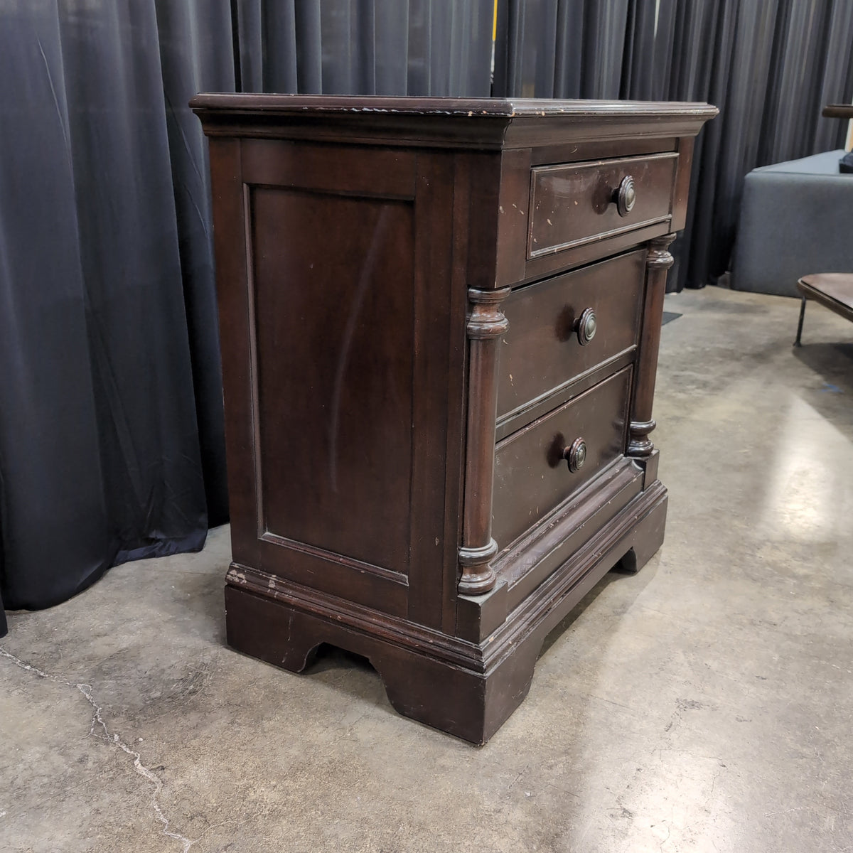Dark Hardwood Three-Drawer Nightstand with Turned Columns