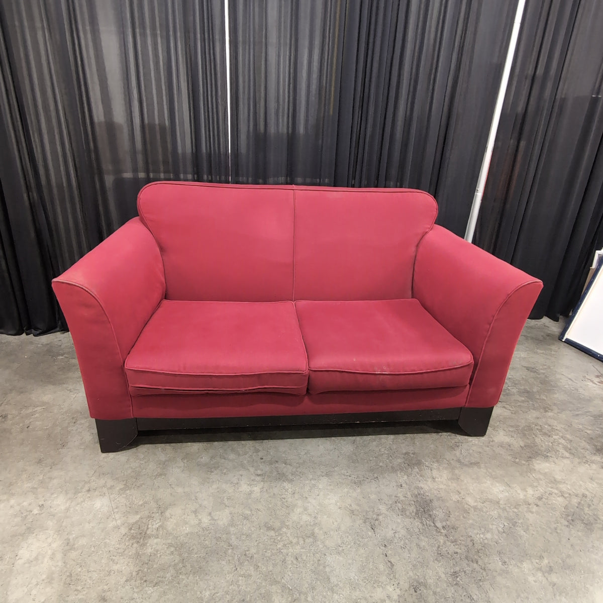 Red Upholstered Two-Cushion Fabric Loveseat with Dark Wood Base