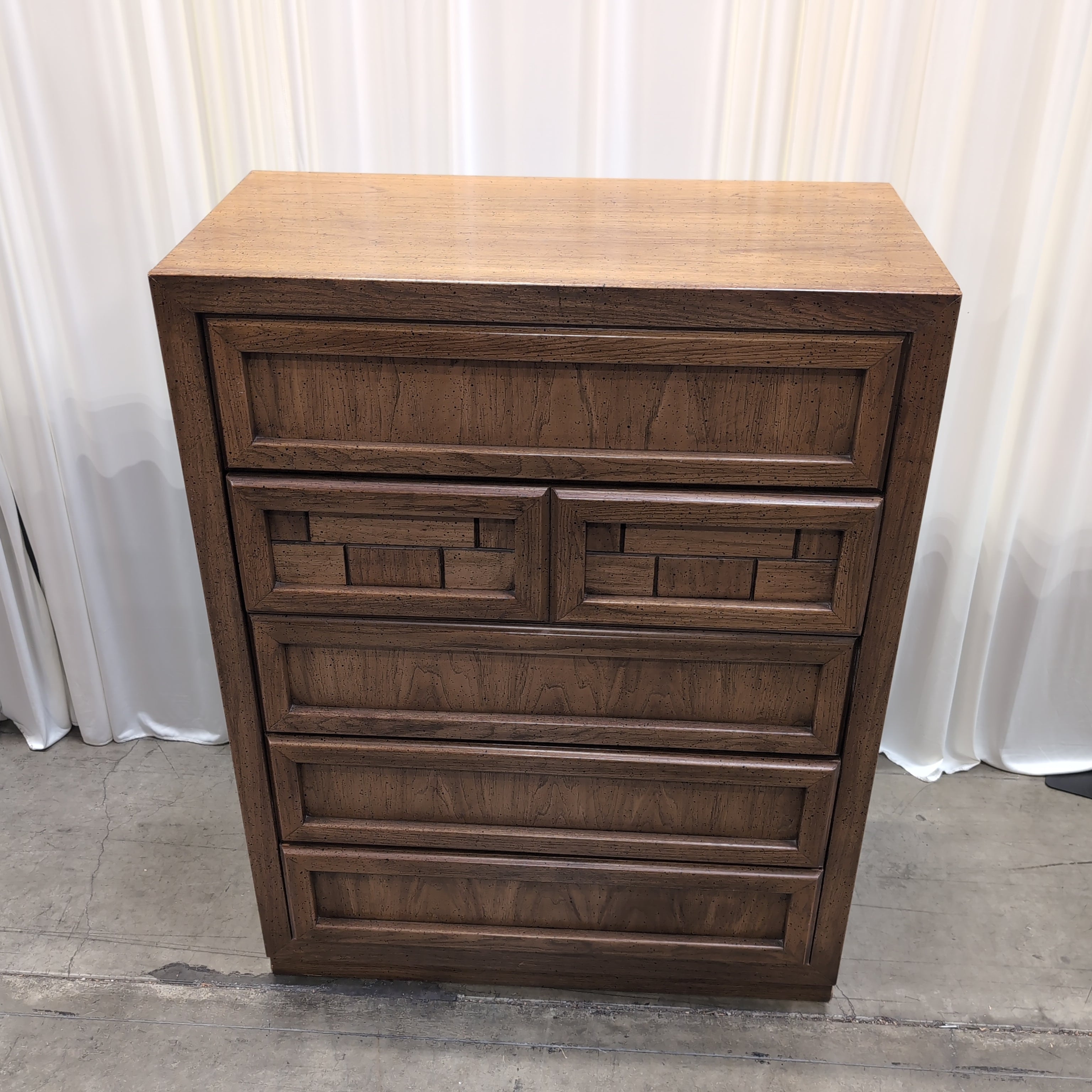 Honey Wood Five-Drawer Dresser with Geometric Top Panels