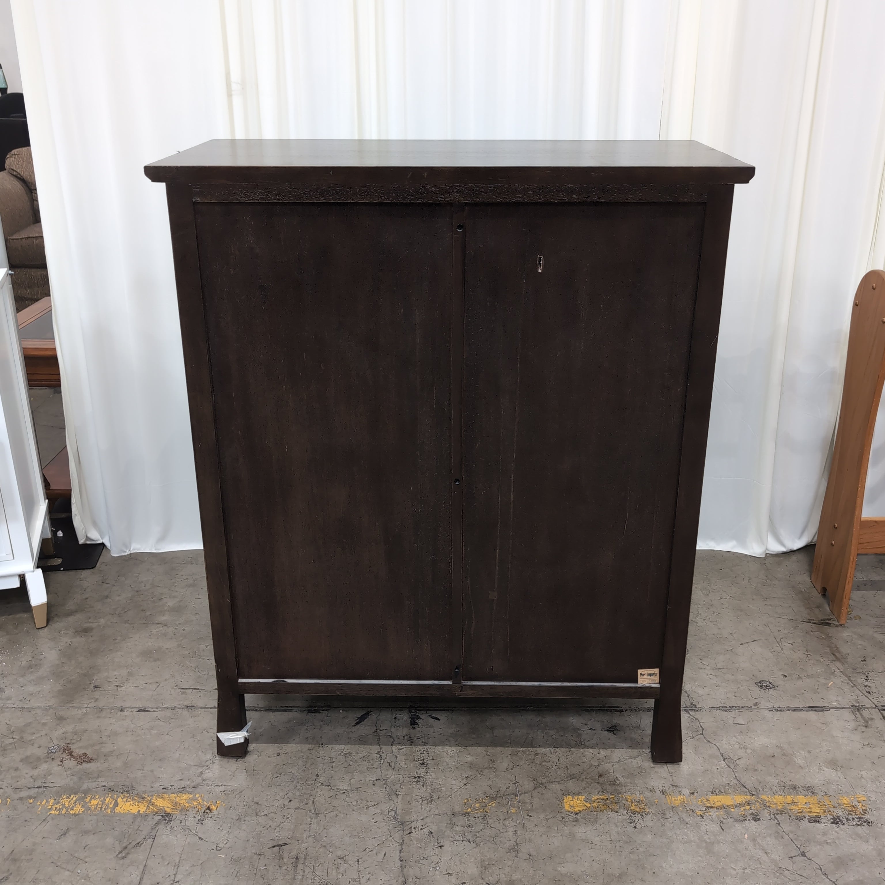 Dark Wood Five-Drawer Dresser with Ornate Panel