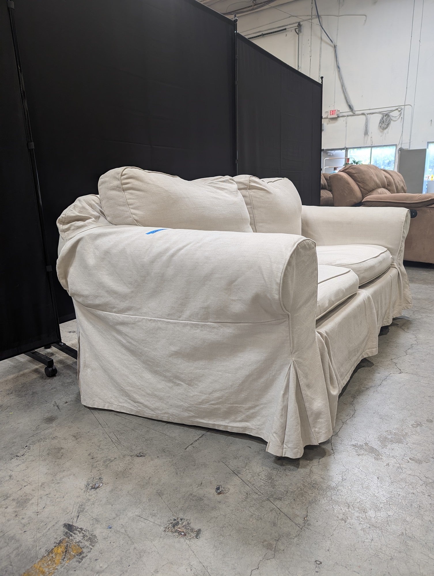 Light Beige Slipcovered Rolled Arm Couch
