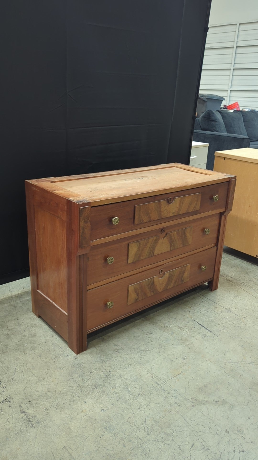 Warm Wood Three-Drawer Dresser with Ornate Hardware