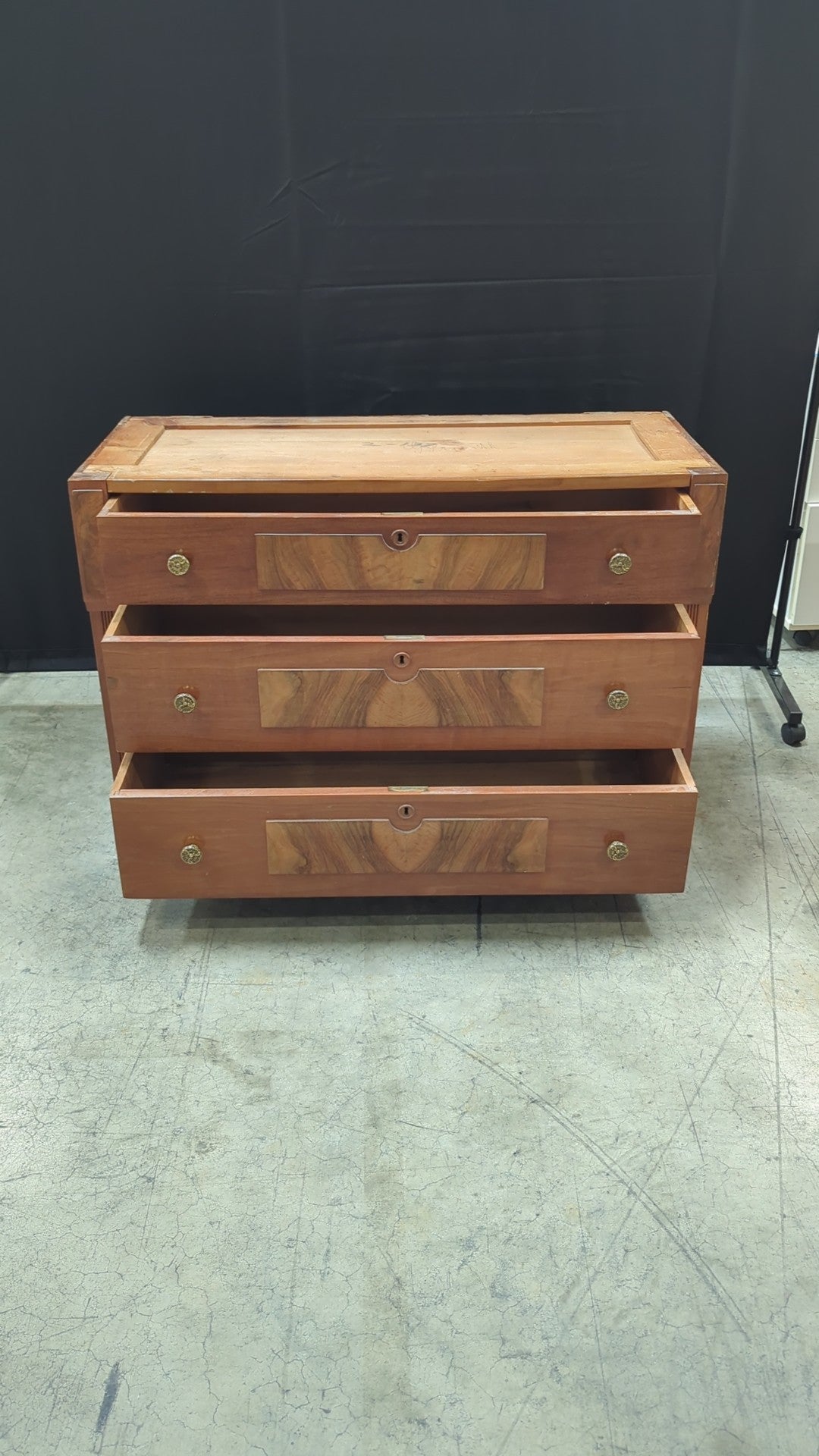 Warm Wood Three-Drawer Dresser with Ornate Hardware