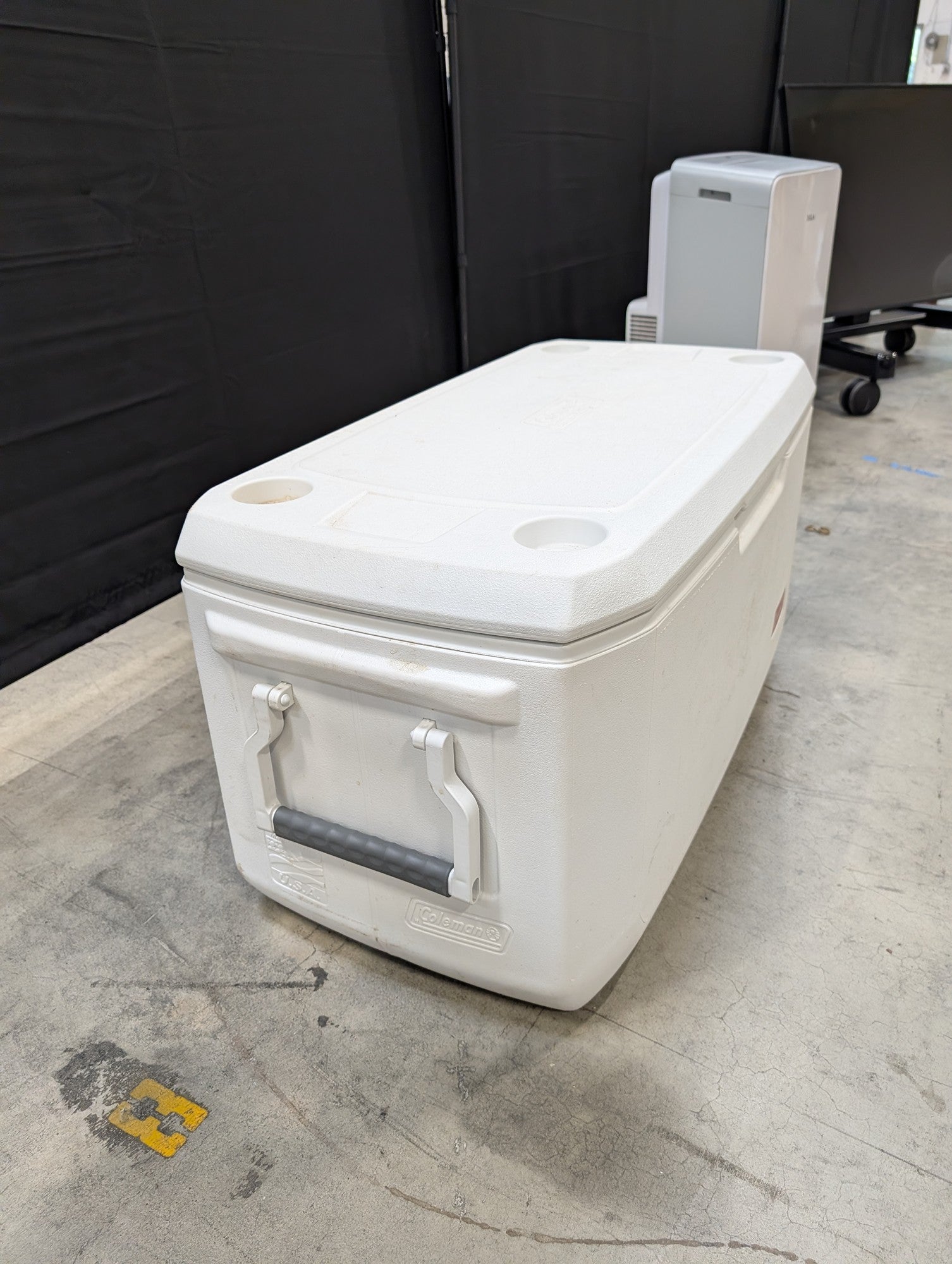 White Coleman Plastic Cooler with Cup Holders