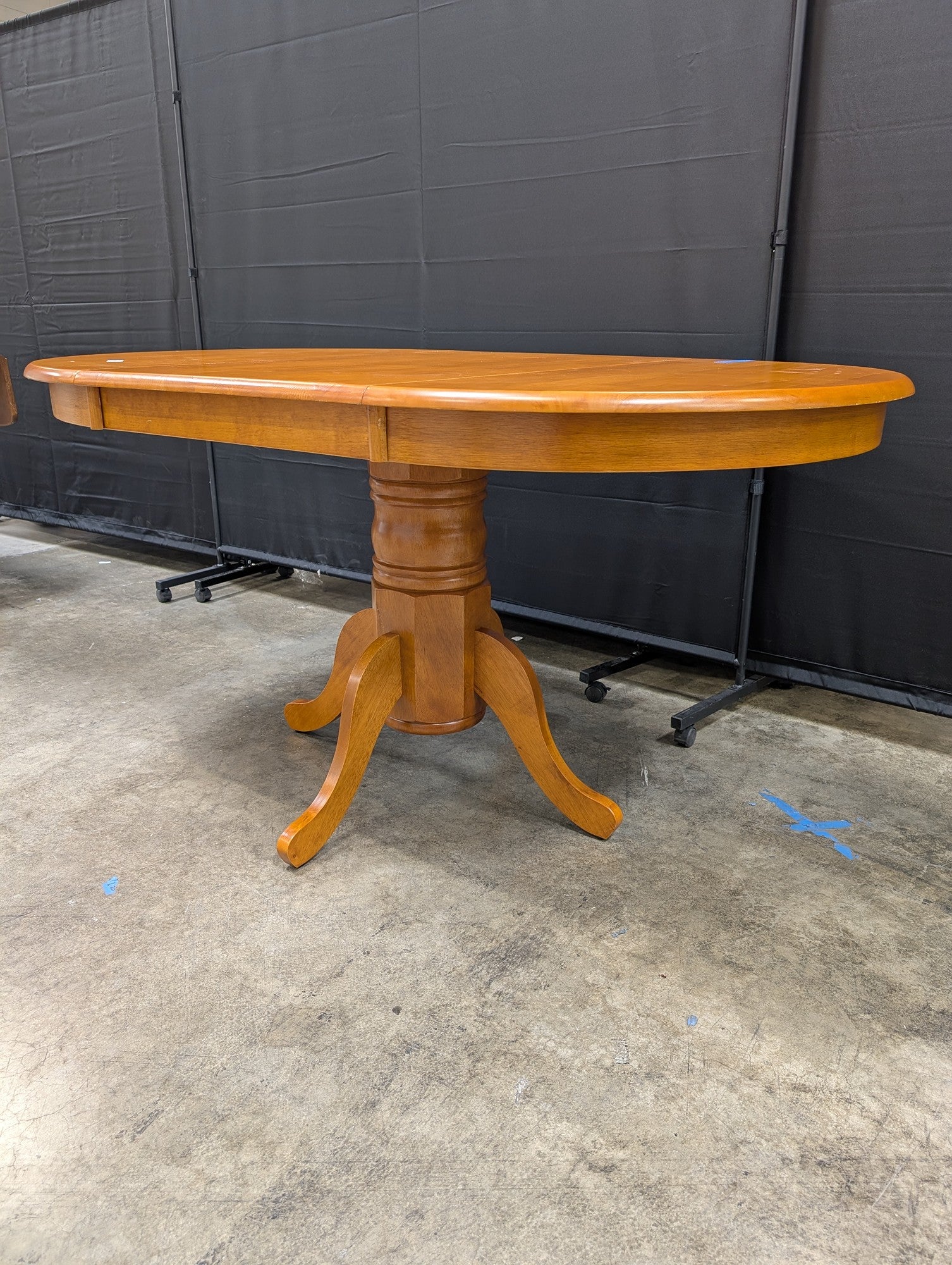 Oval Pedestal Dining Table in Warm Wood