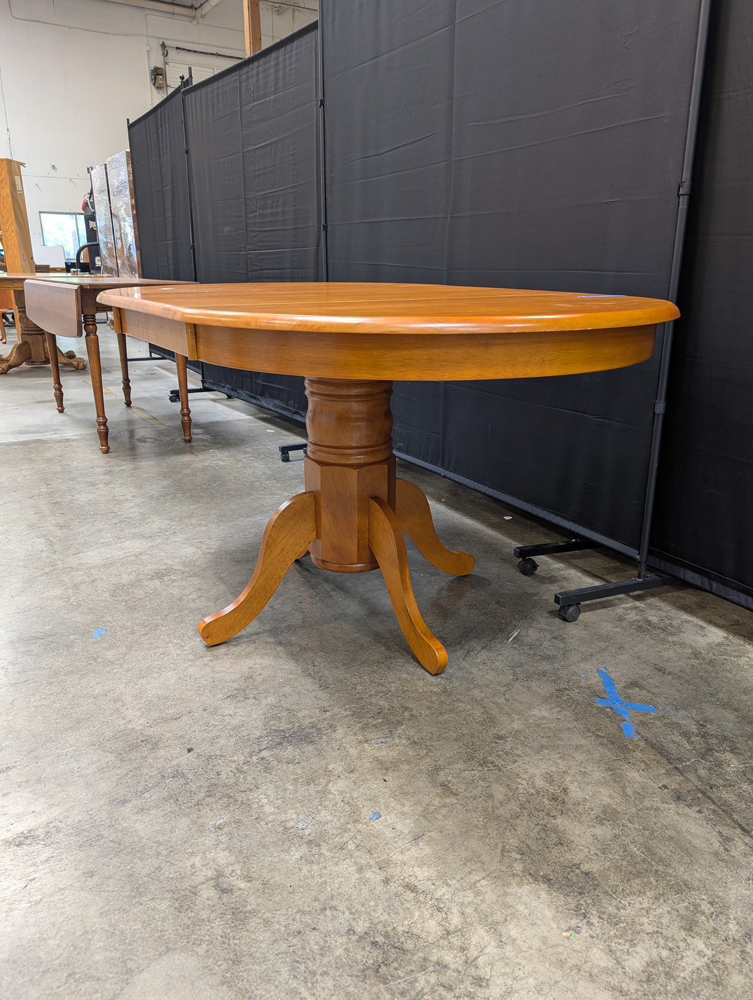 Oval Pedestal Dining Table in Warm Wood
