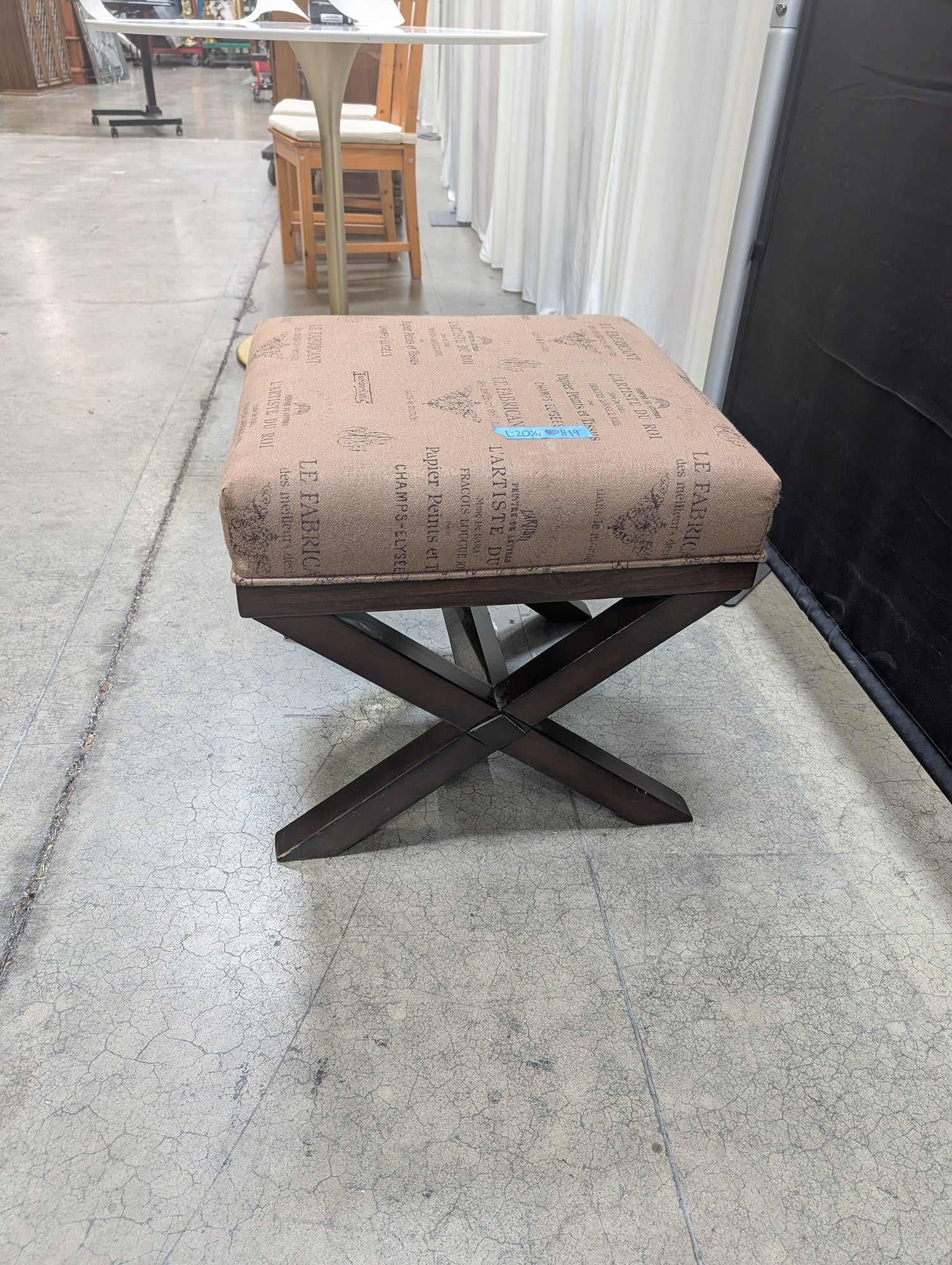 Ashley French Script Upholstered Ottoman with X-Base
