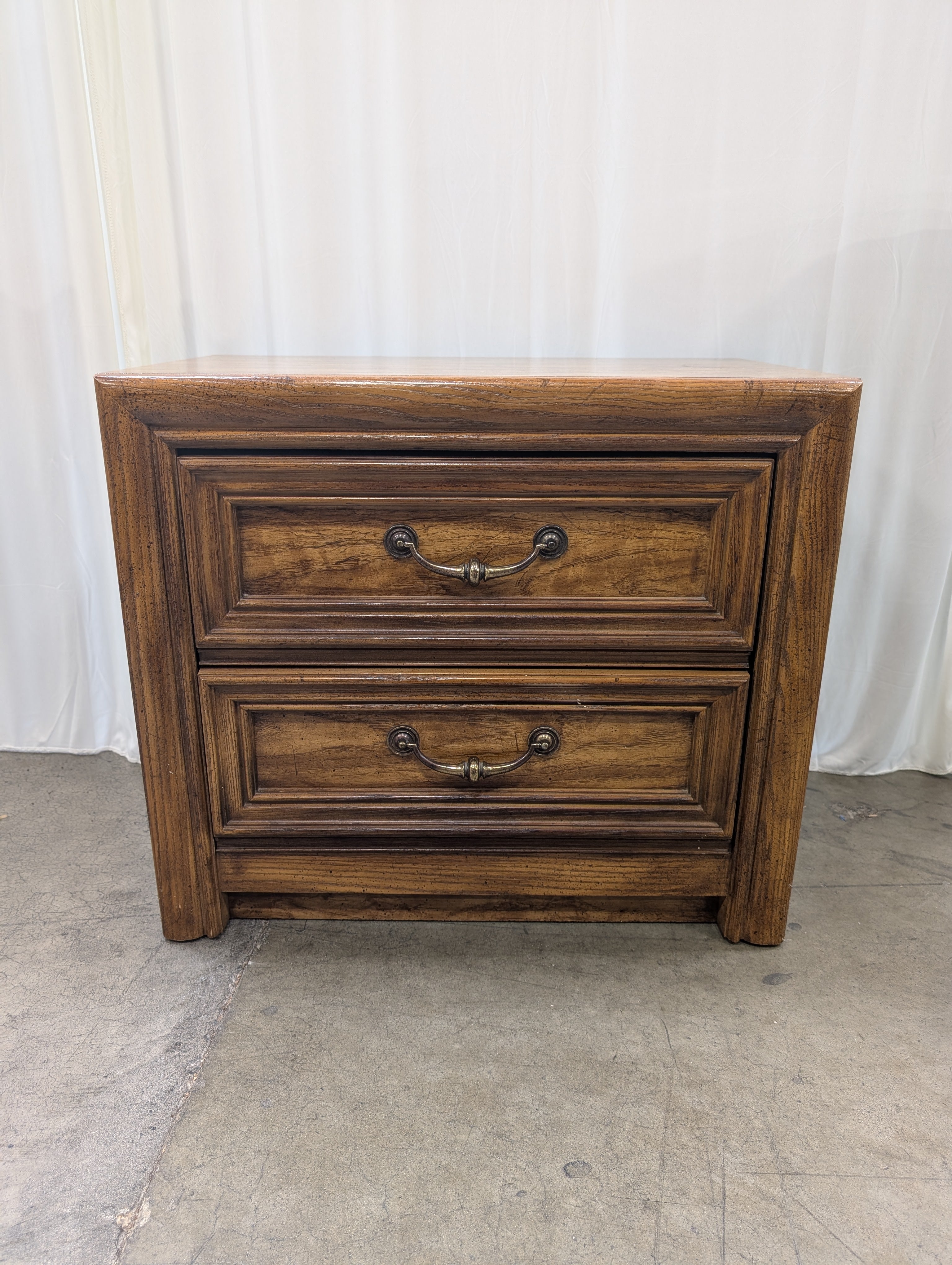 Warm Brown Wood Two-Drawer Nightstand with Ornate Hardware
