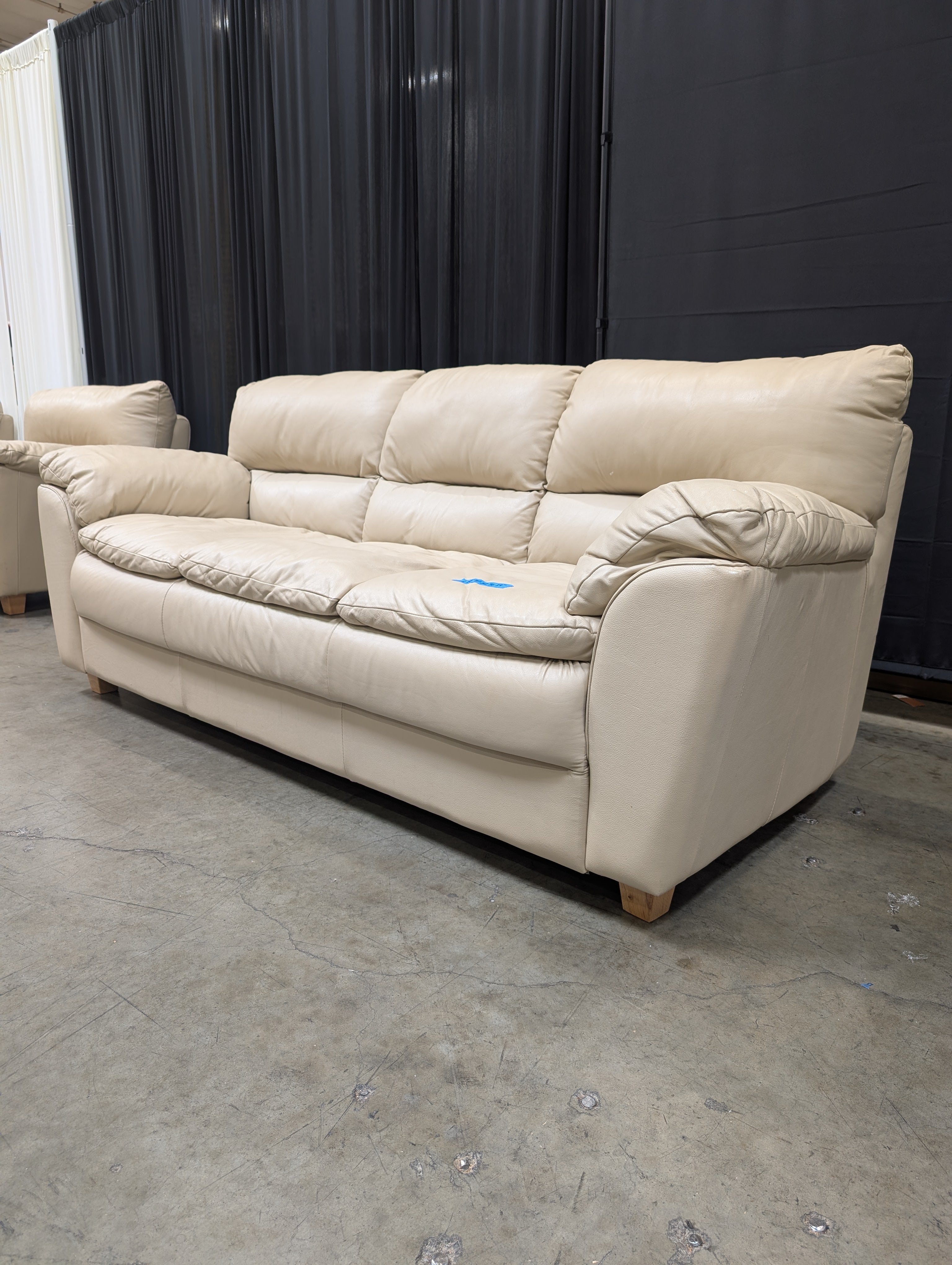 Cream Three-Seat Leather Couch with Pillow Arms