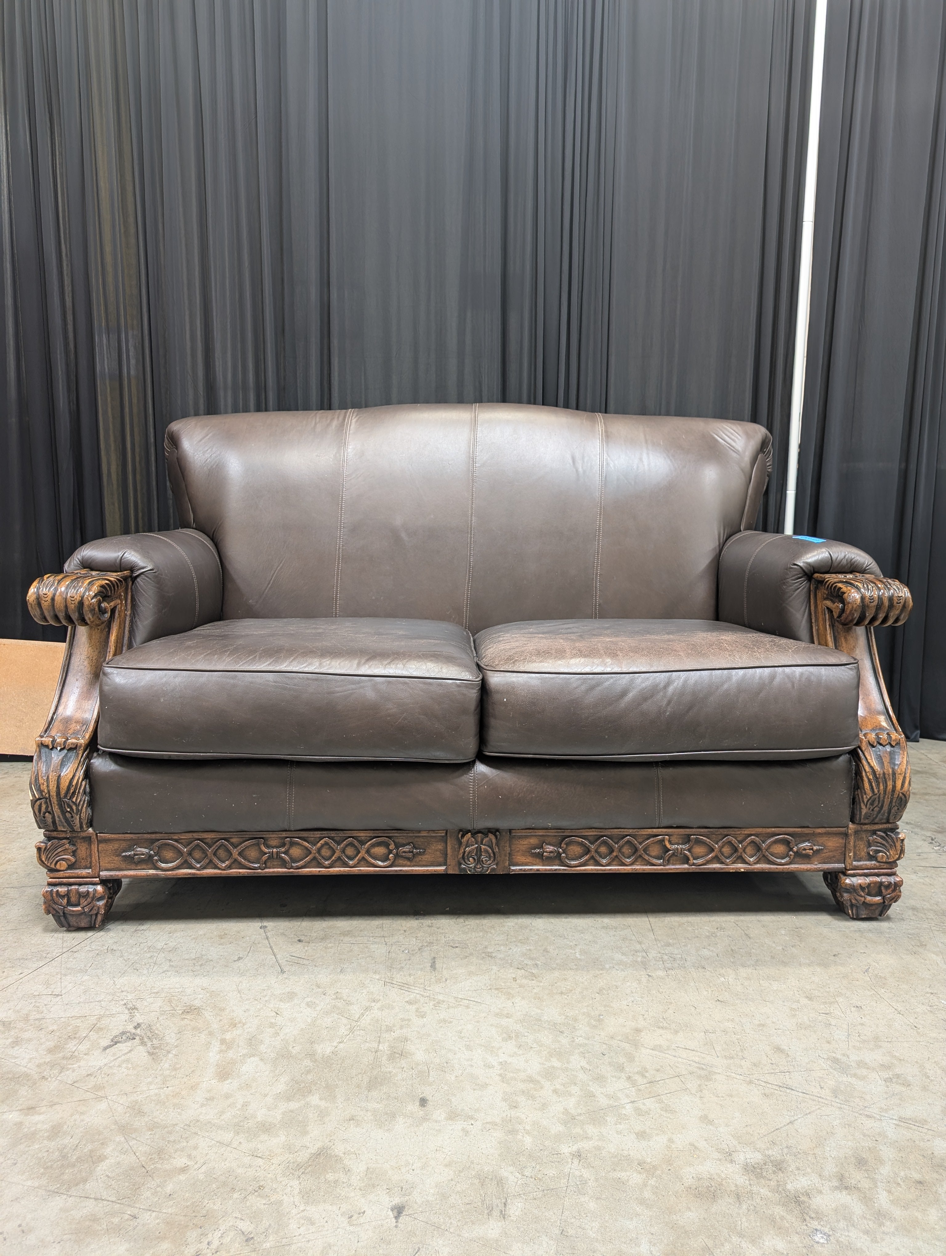 Traditional Brown Leather Loveseat with Carved Wood
