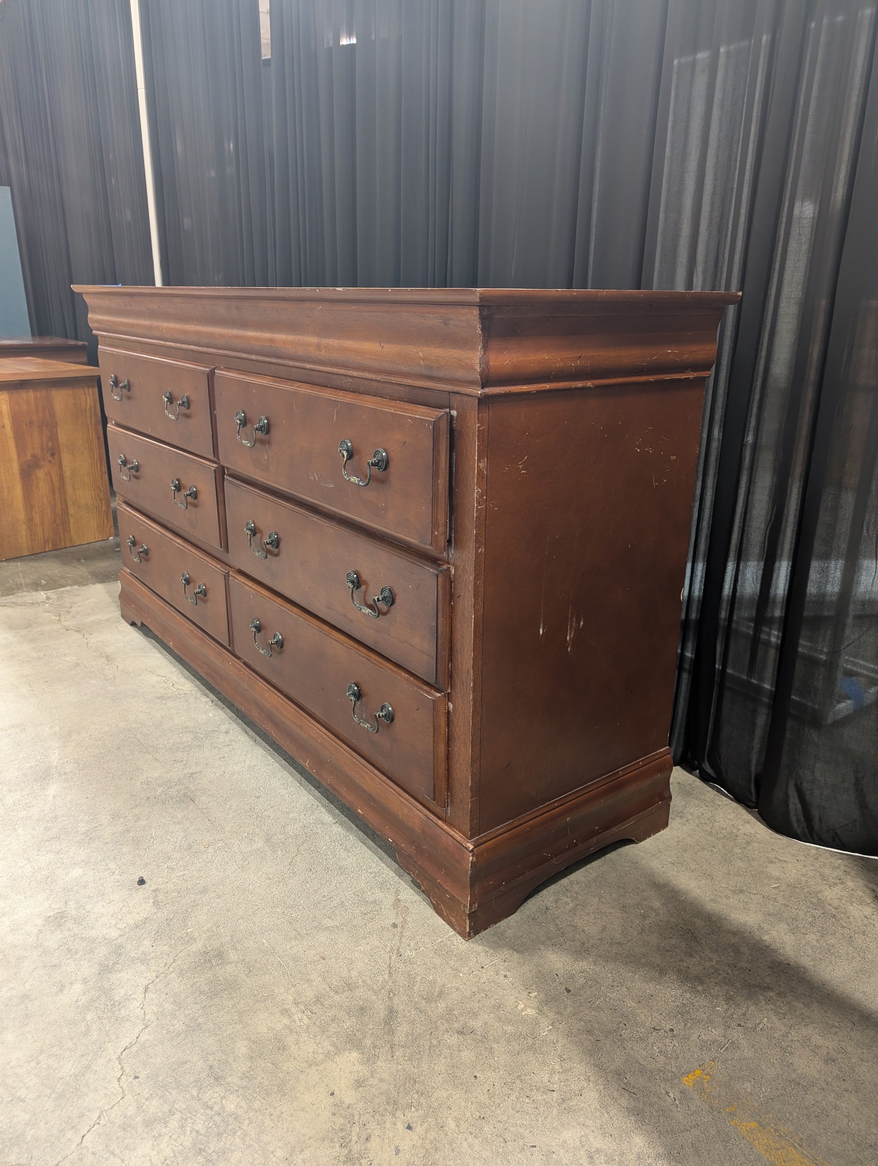 Dark Wood Six-Drawer Dresser with Ornate Hardware