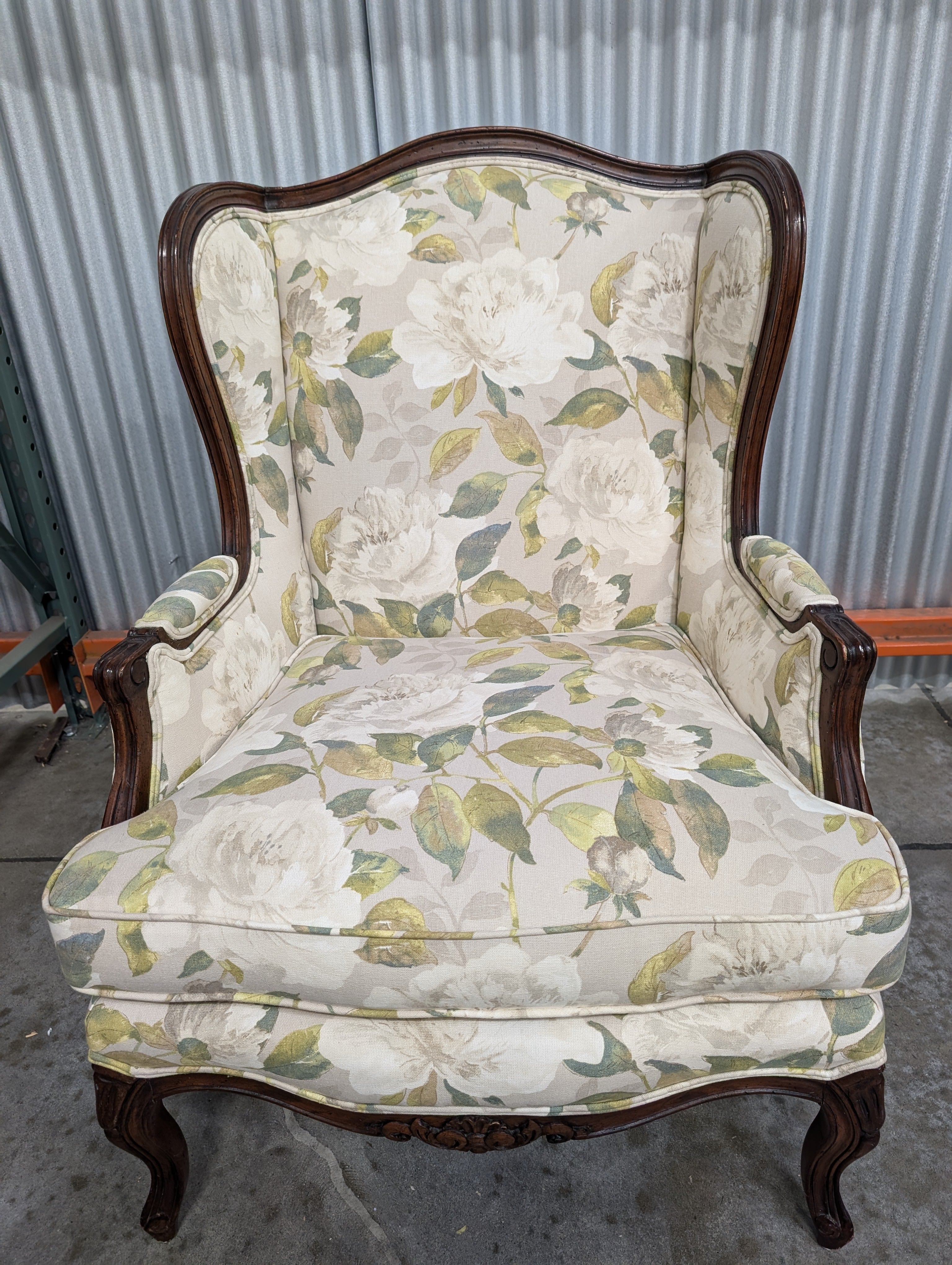Vintage Wingback Armchair with Floral Upholstery and Carved Wood Frame