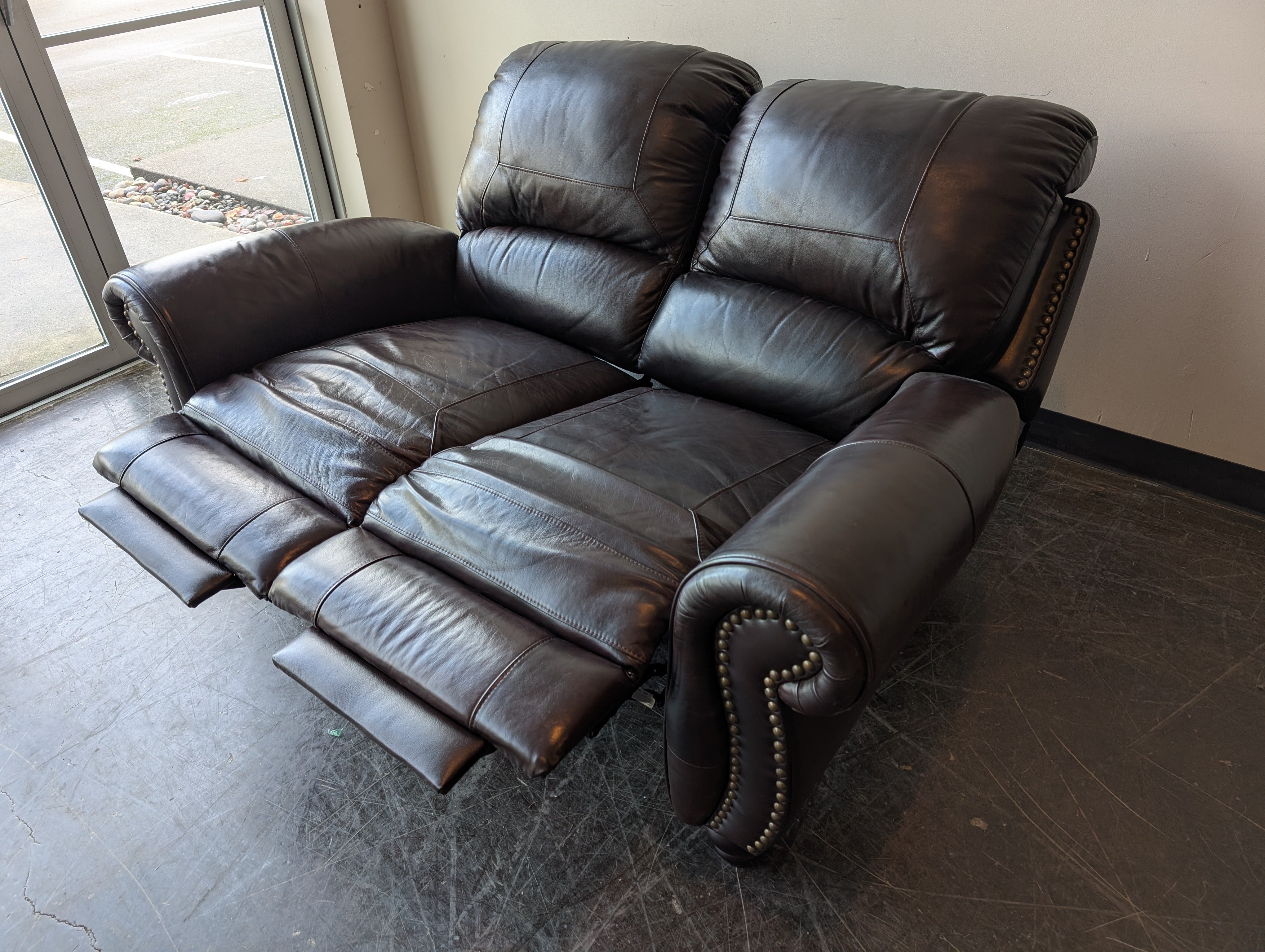 Classic Dark Brown Leather Reclining Loveseat with Nailhead Trim