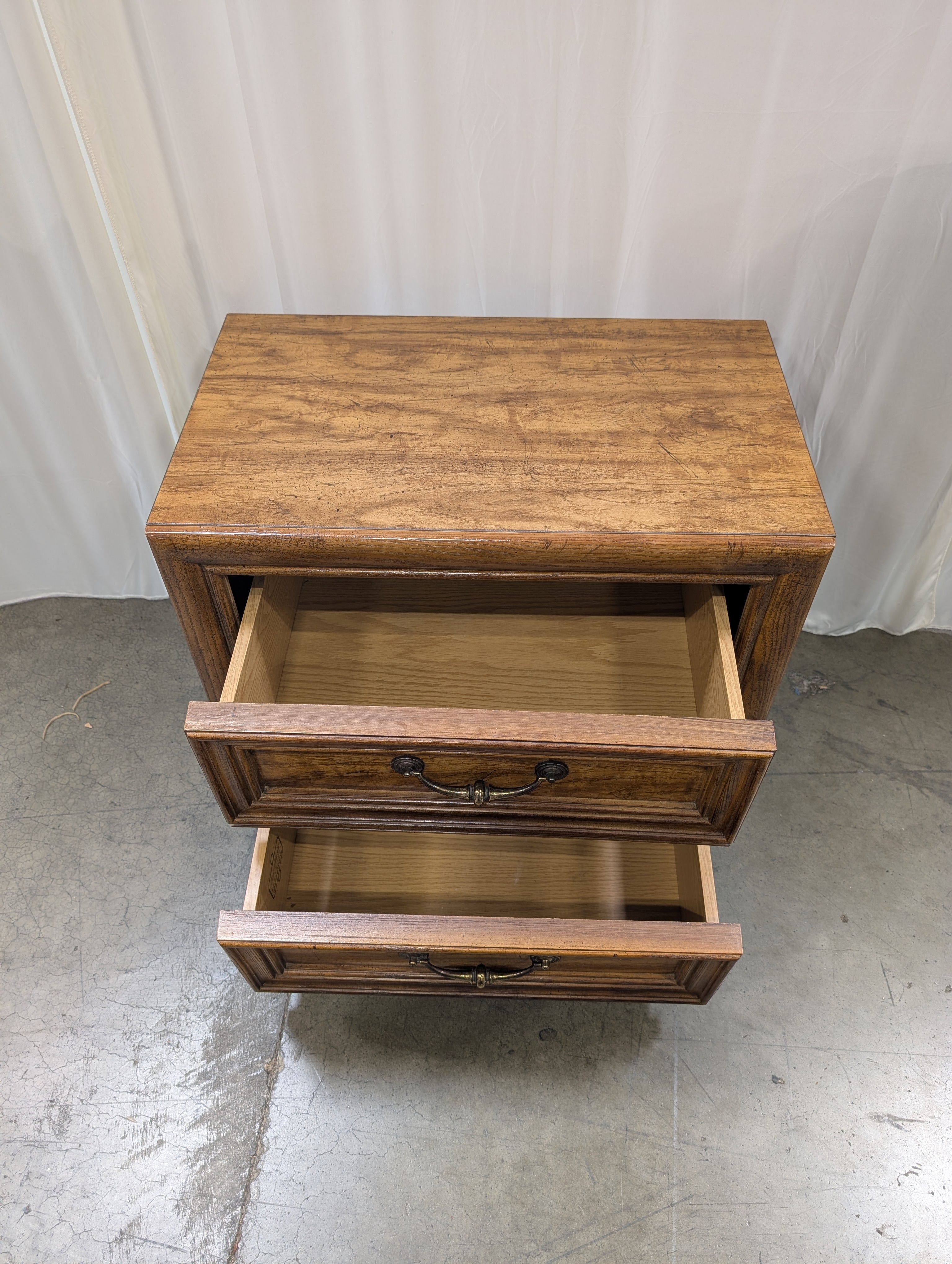 Warm Brown Wood Two-Drawer Nightstand with Ornate Hardware