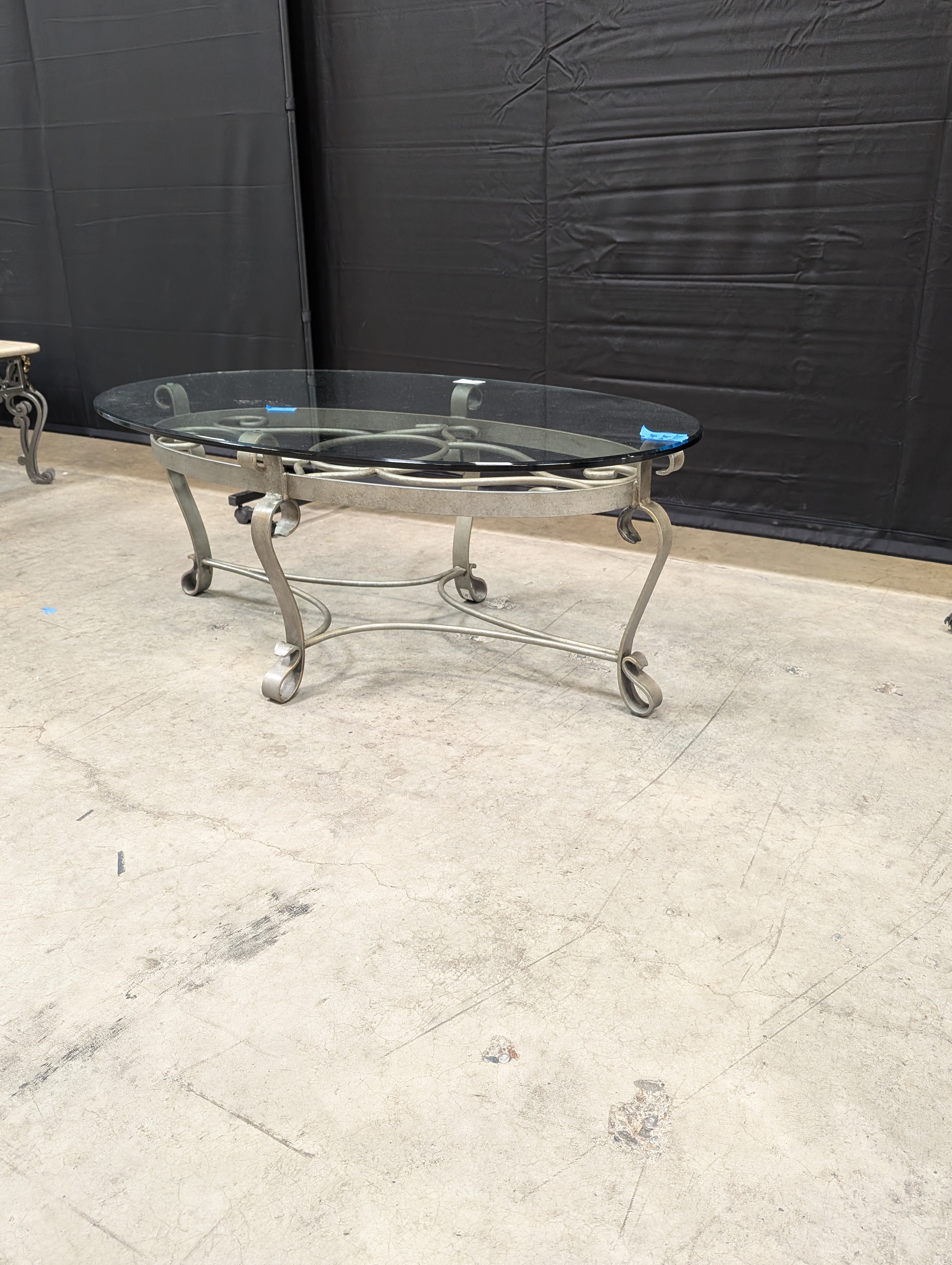 Oval Glass Top Coffee Table with Ornate Scrolled Metal Base