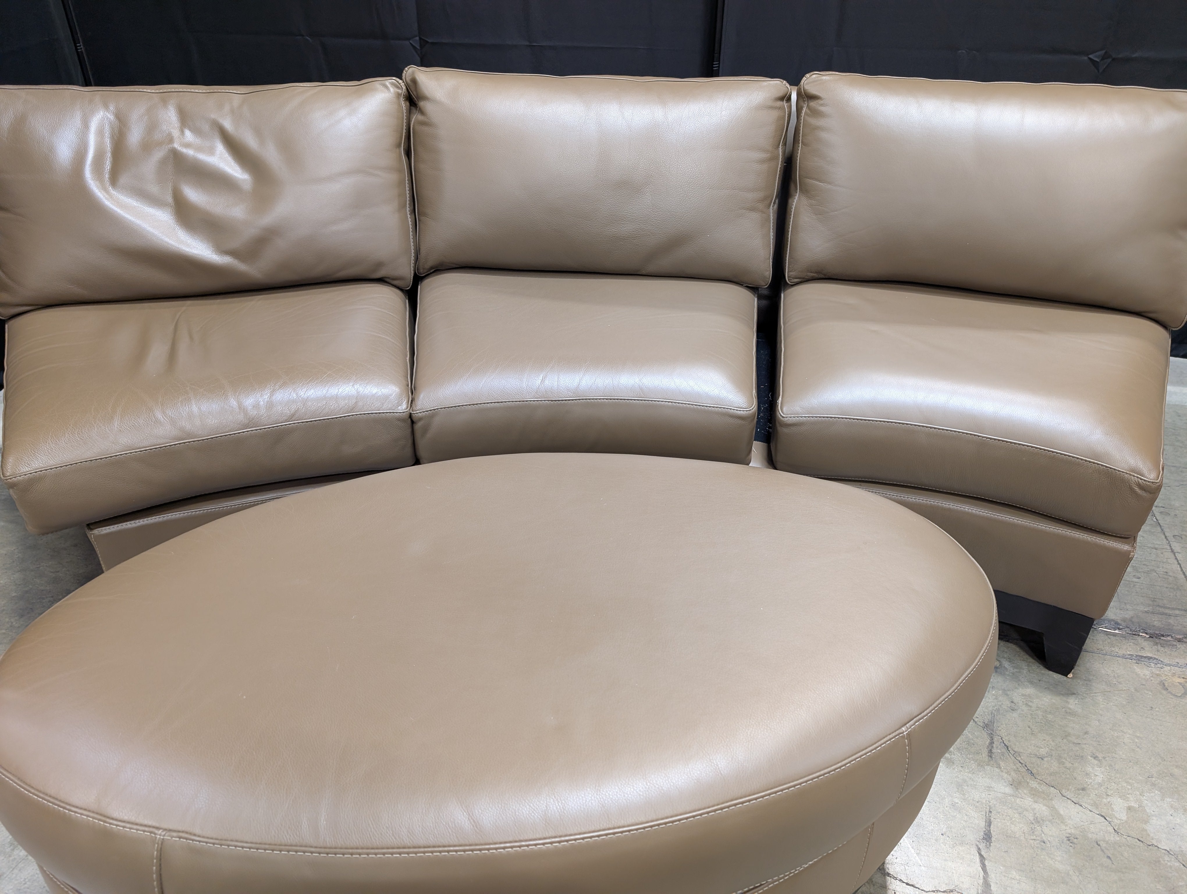 Contemporary Brown Leather Curved Sectional Sofa with Matching Round Ottoman