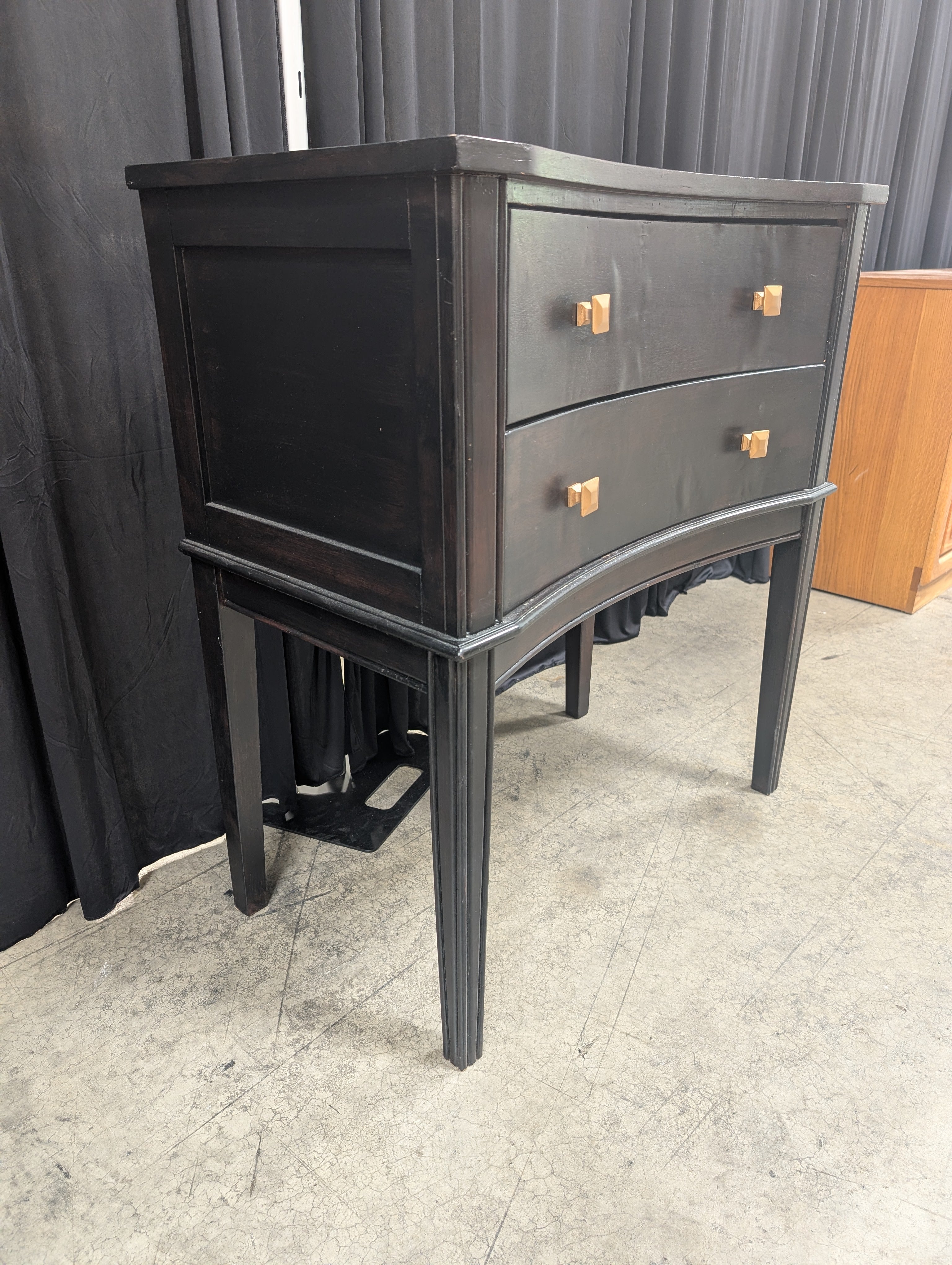 Black Curved Wood Nightstand with Gold Knobs