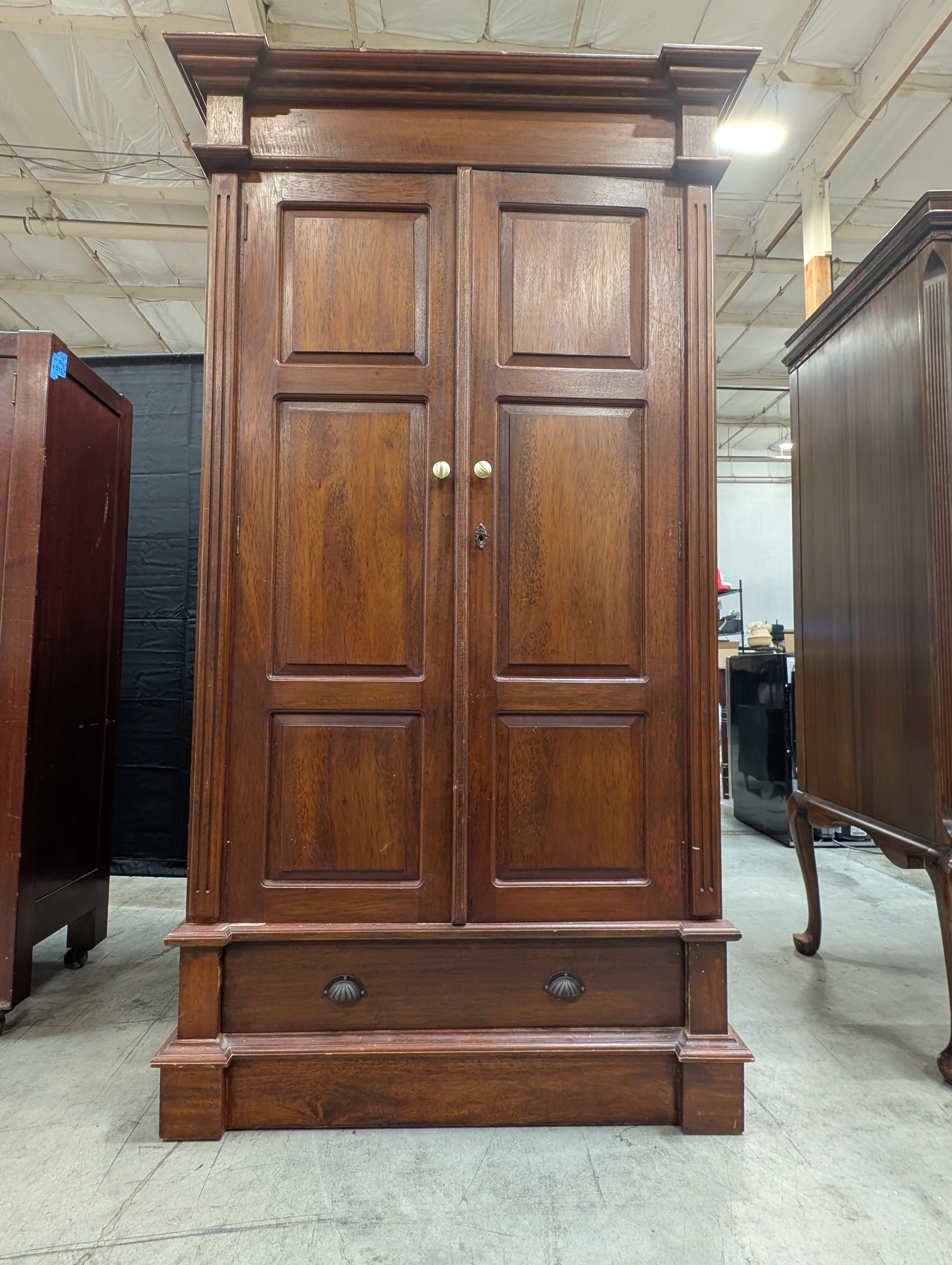 Stately Dark Wood Paneled Armoire with Drawer