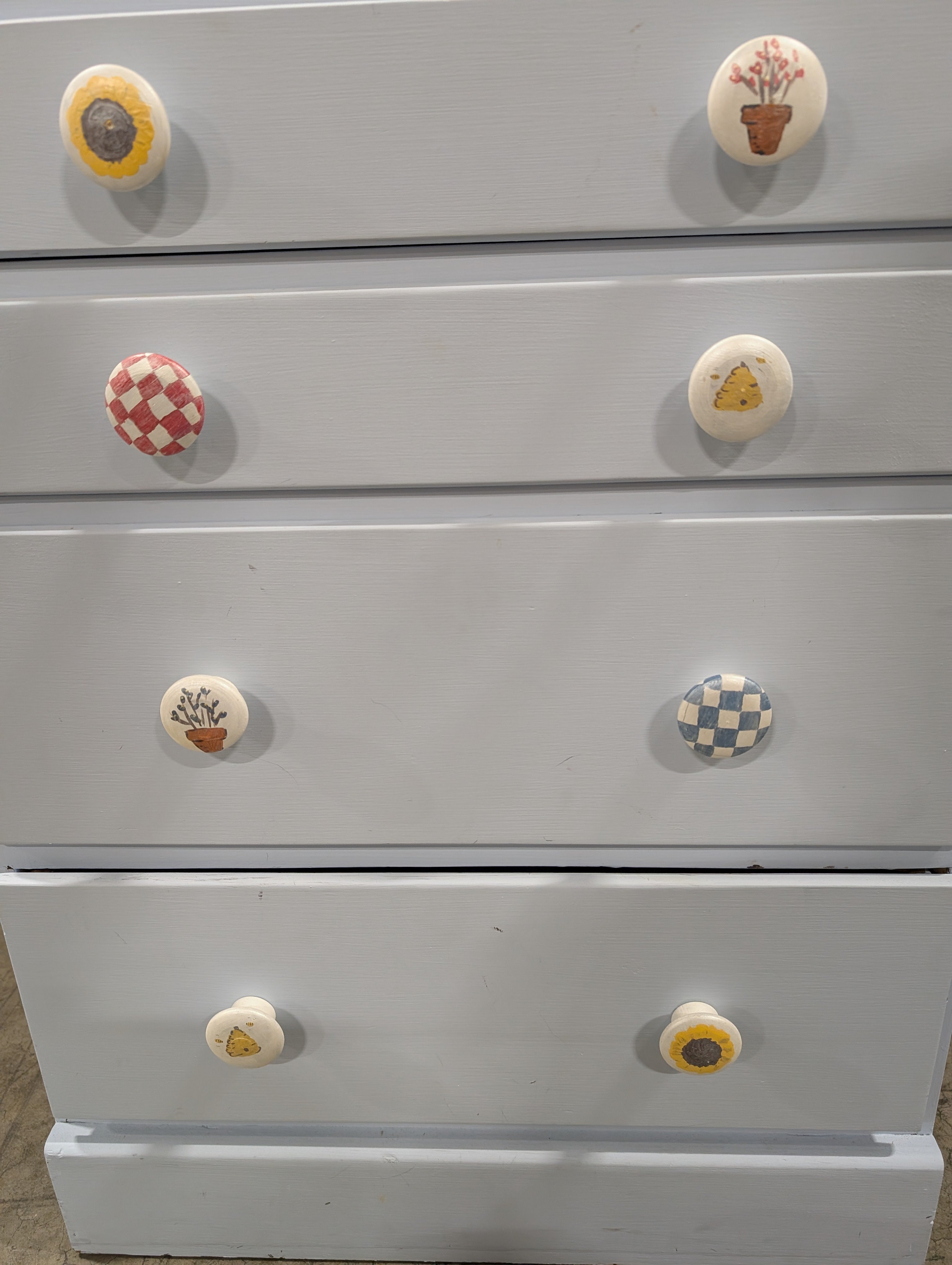 Pale Blue Wooden Four-Drawer Chest with Decorative Knobs