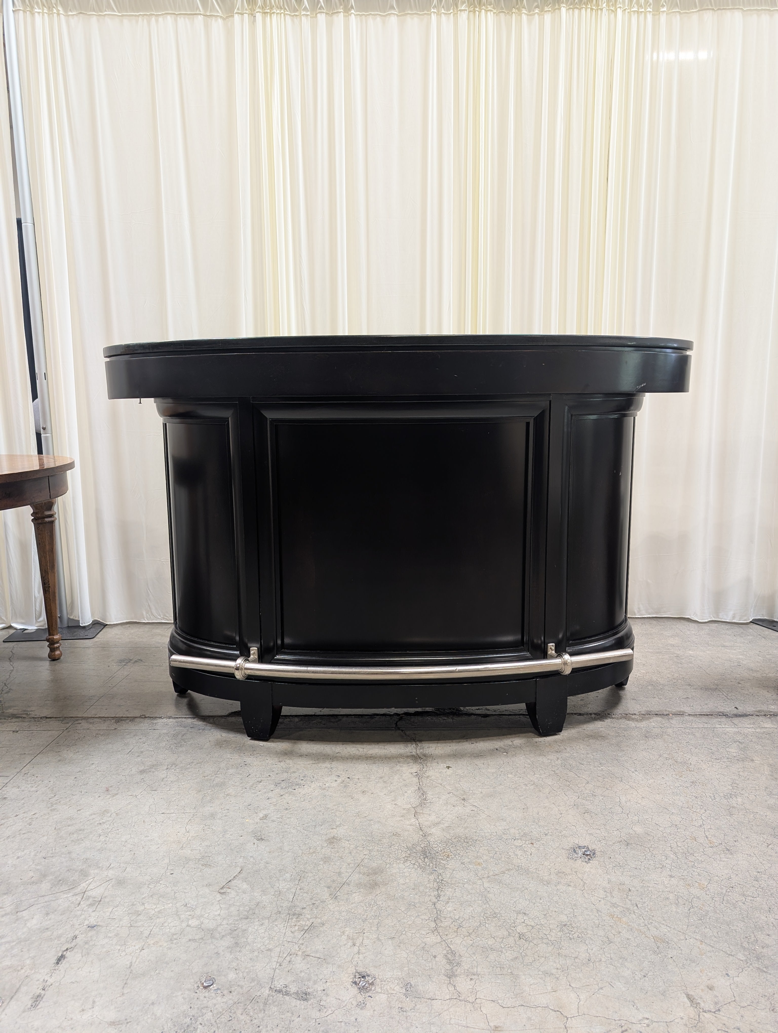 Dark Curved Wood Home Bar with Metal Foot Rail
