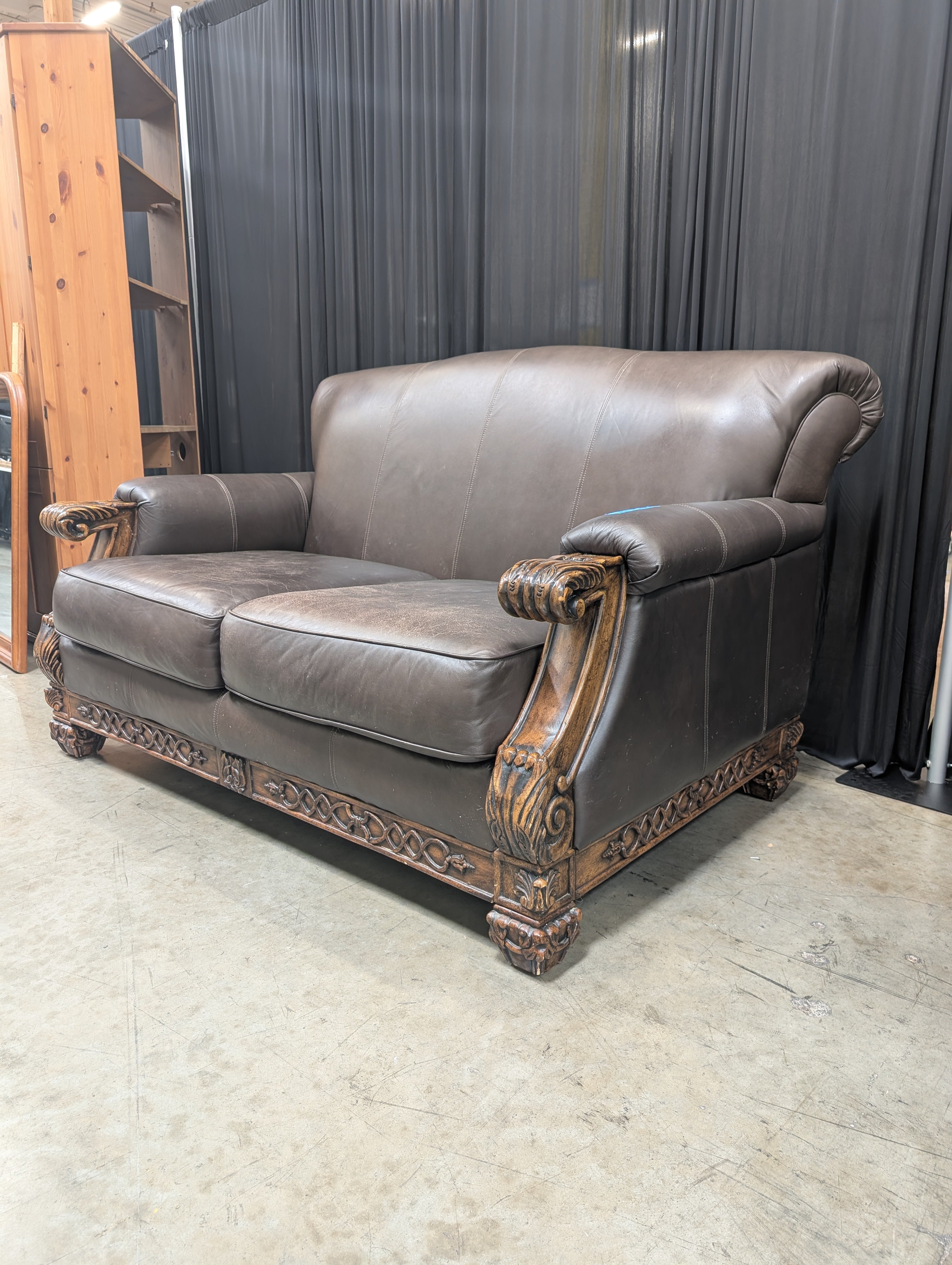 Traditional Brown Leather Loveseat with Carved Wood
