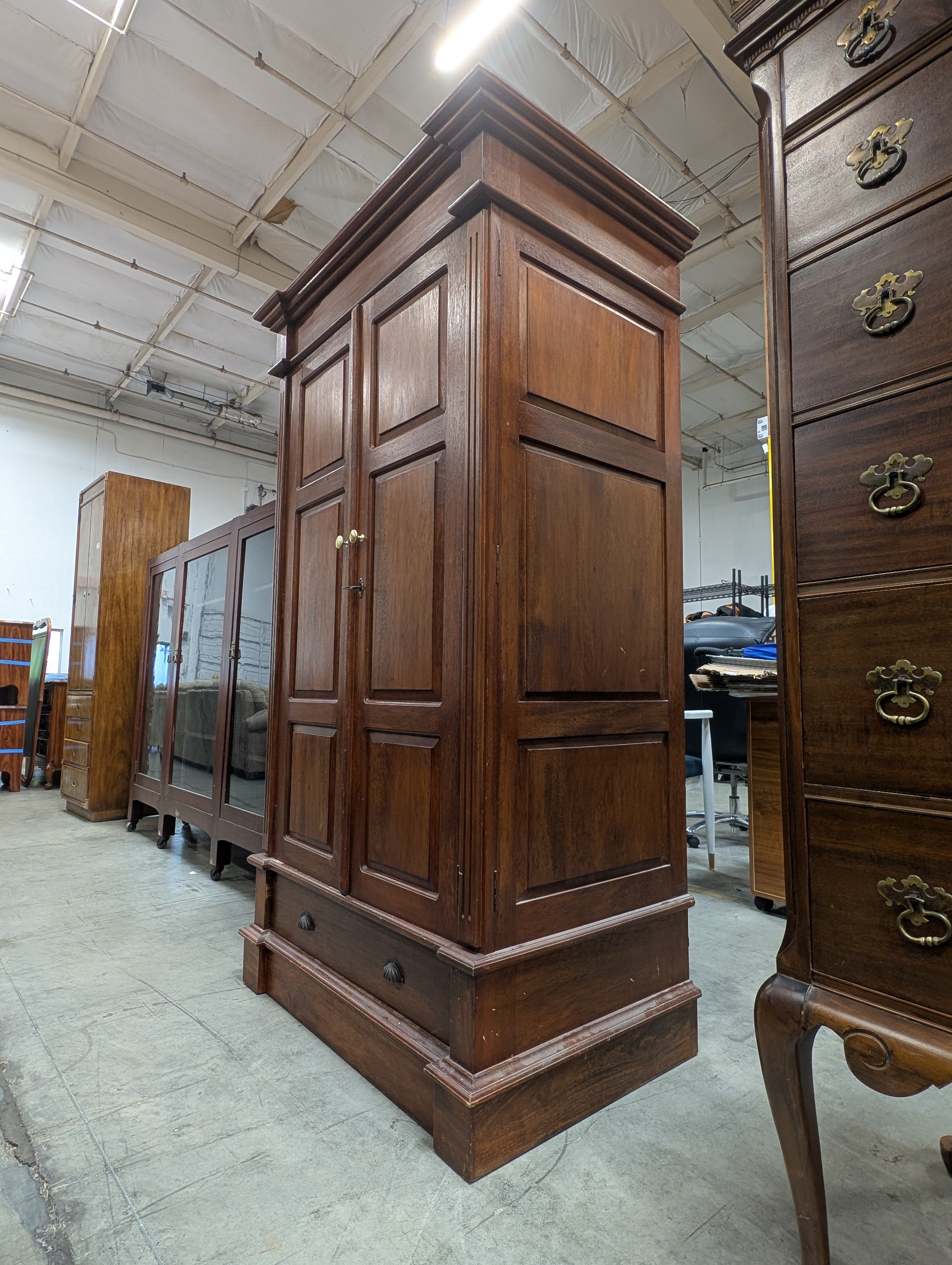 Stately Dark Wood Paneled Armoire with Drawer