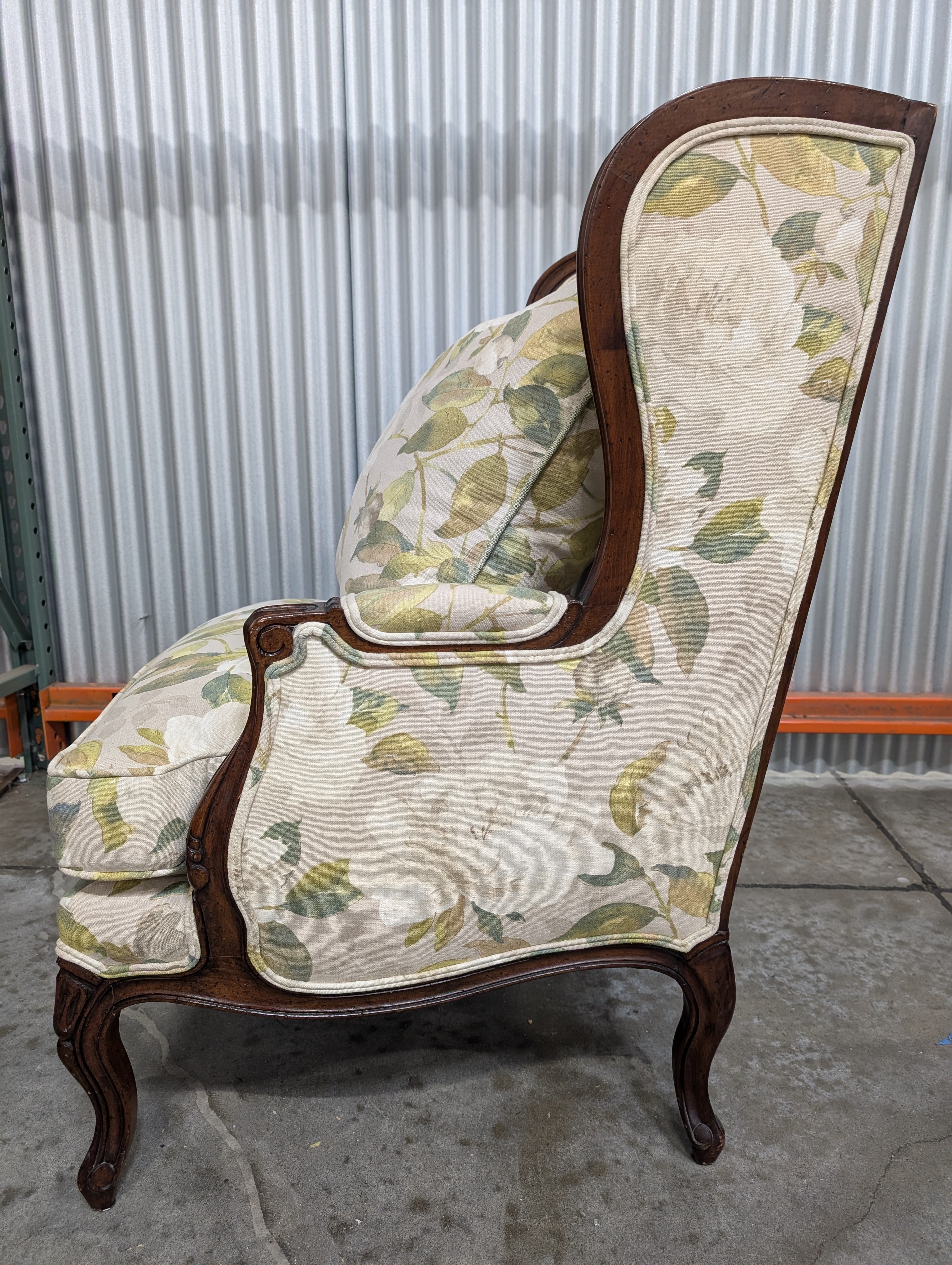 Vintage Wingback Armchair with Floral Upholstery and Carved Wood Frame