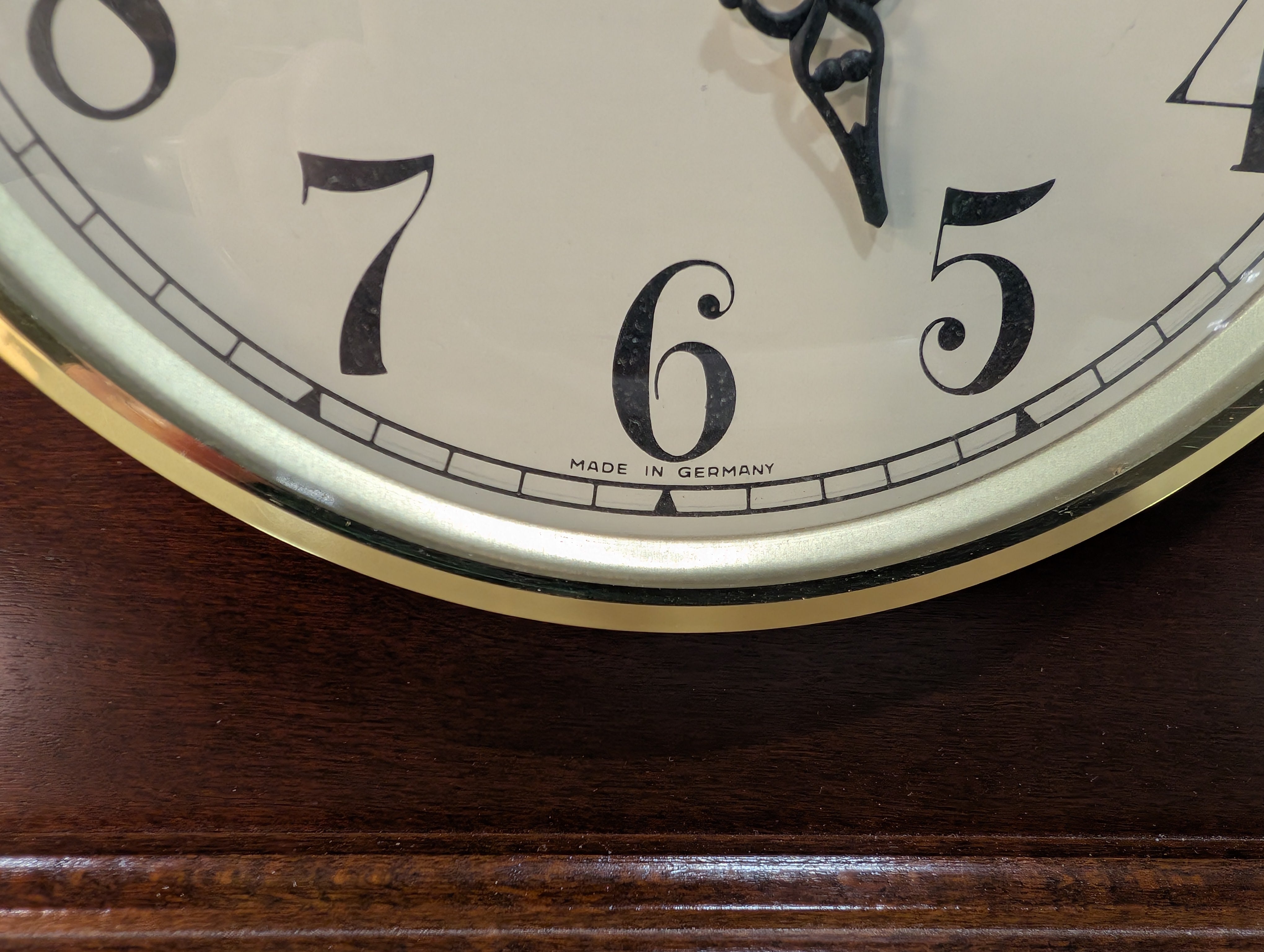Curved Dark Wood Table Clock with Brass Tone Bezel