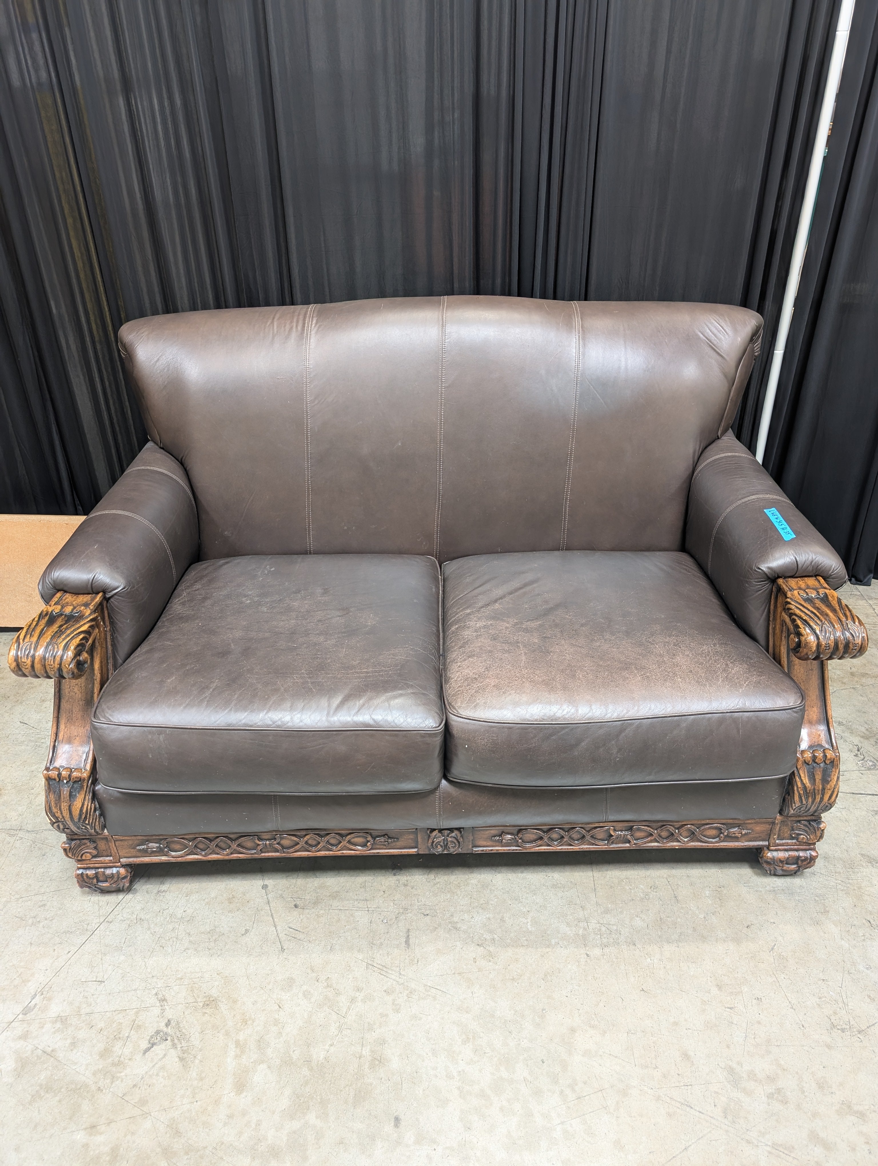 Traditional Brown Leather Loveseat with Carved Wood