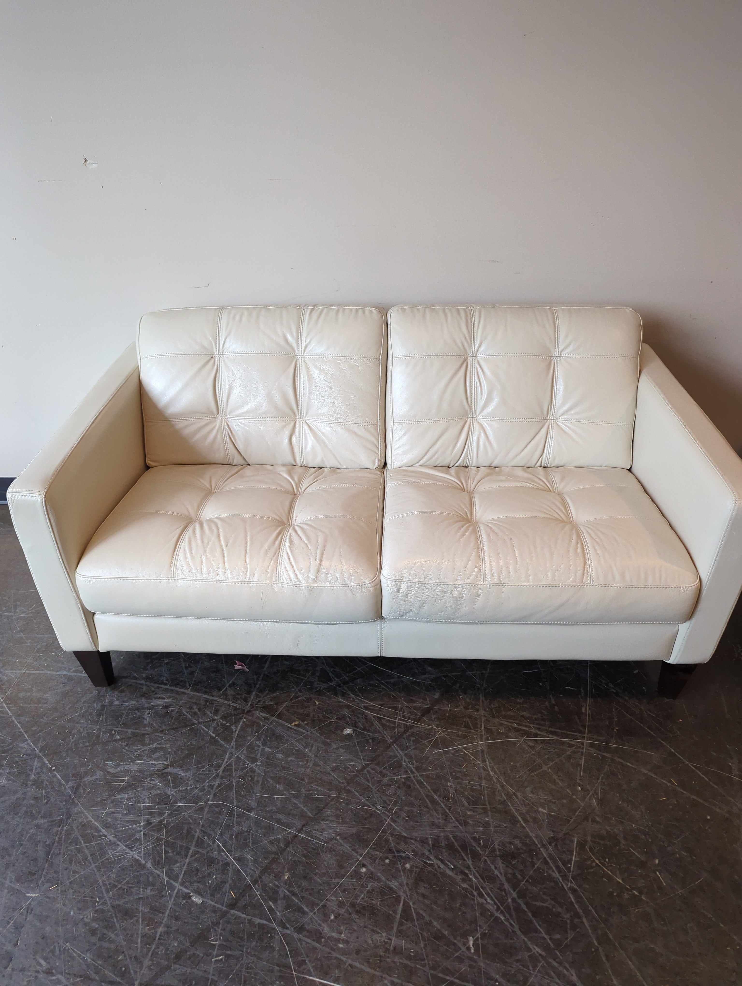Chateau d'Ax Cream Leather Two-Seater Sofa with Tufted Cushions