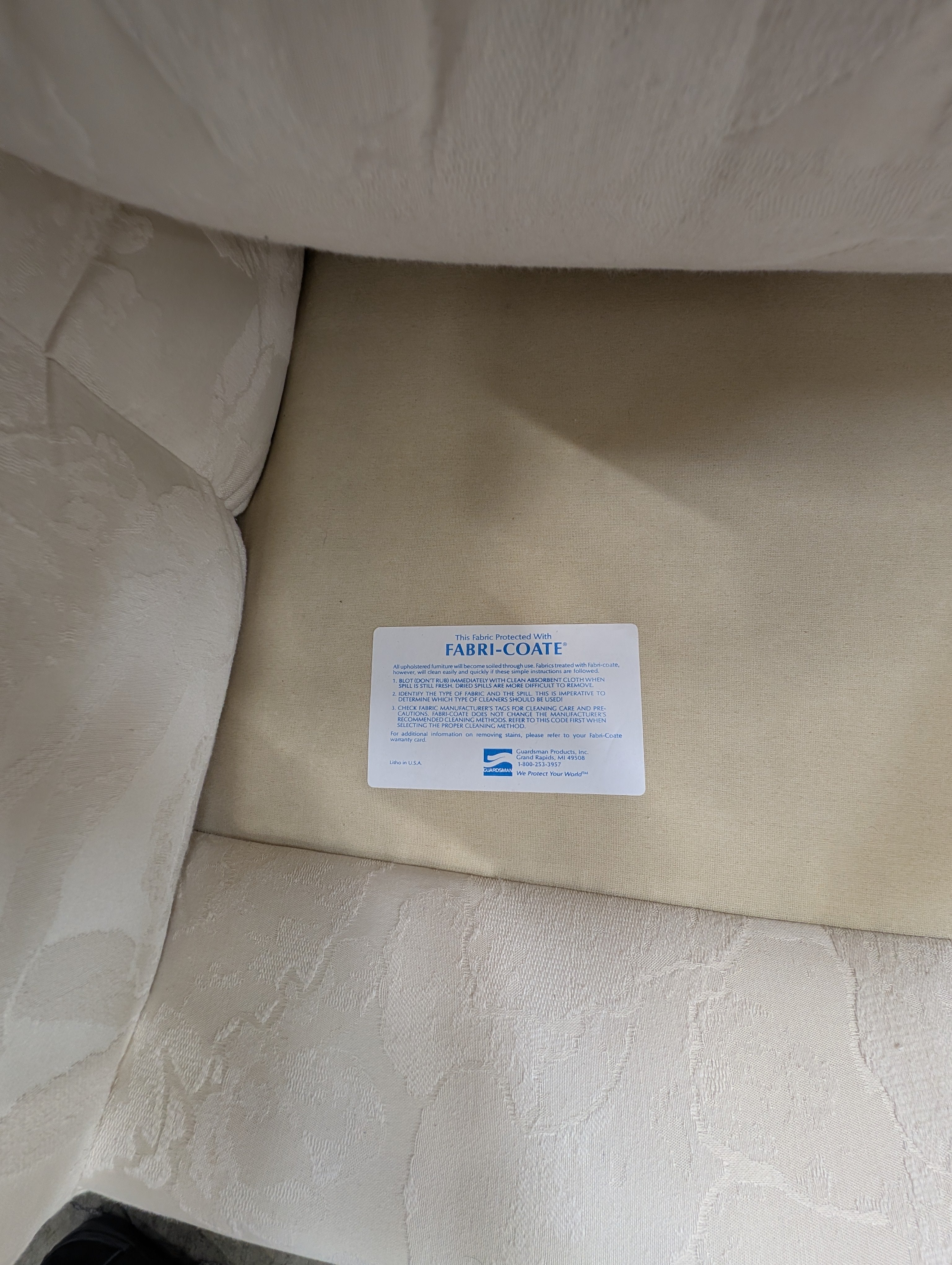 Has a stain Curved Cream Fabric Sectional Sofa with Rolled Arms