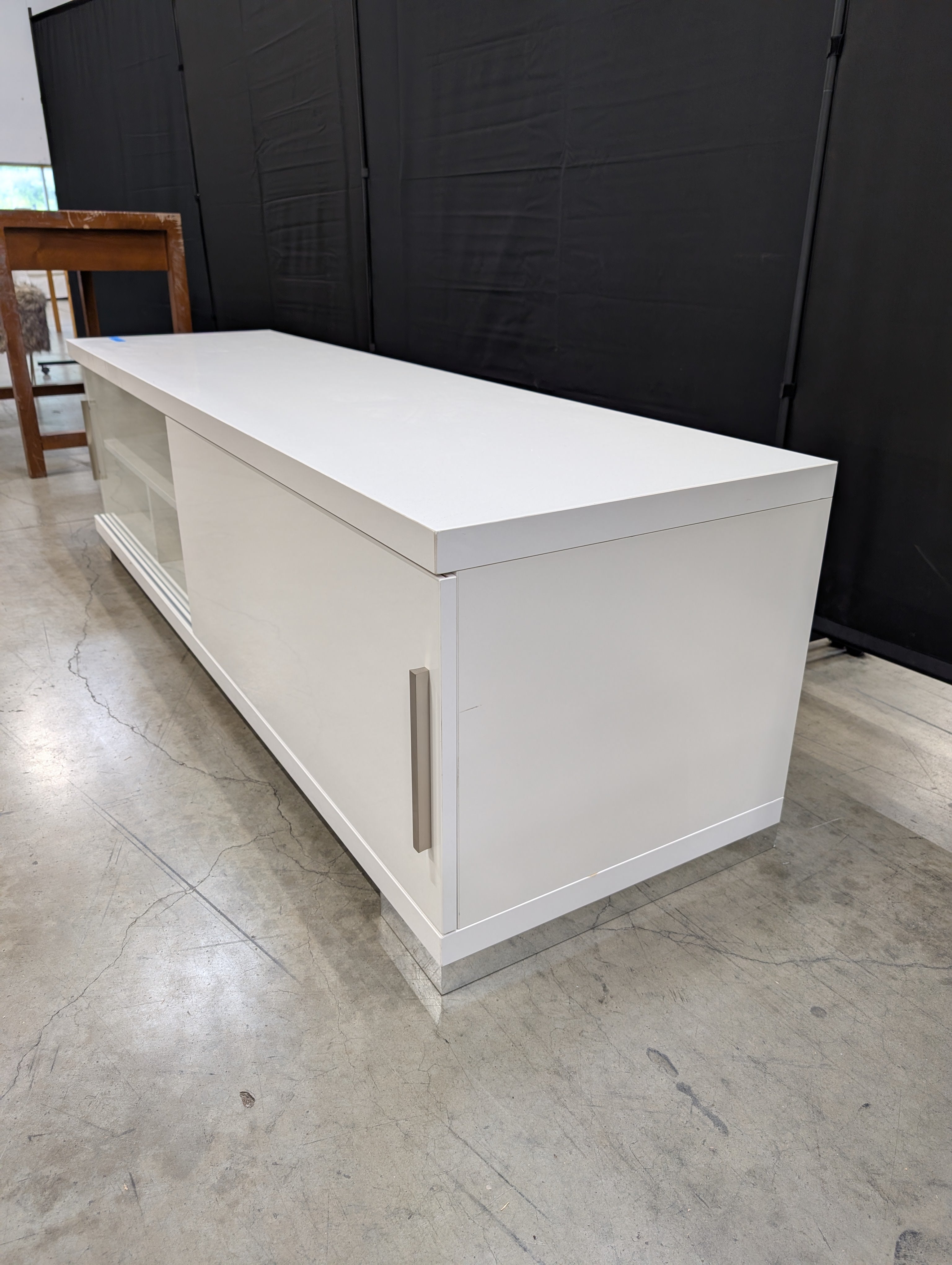 Sleek White Entertainment Unit with Sliding Doors