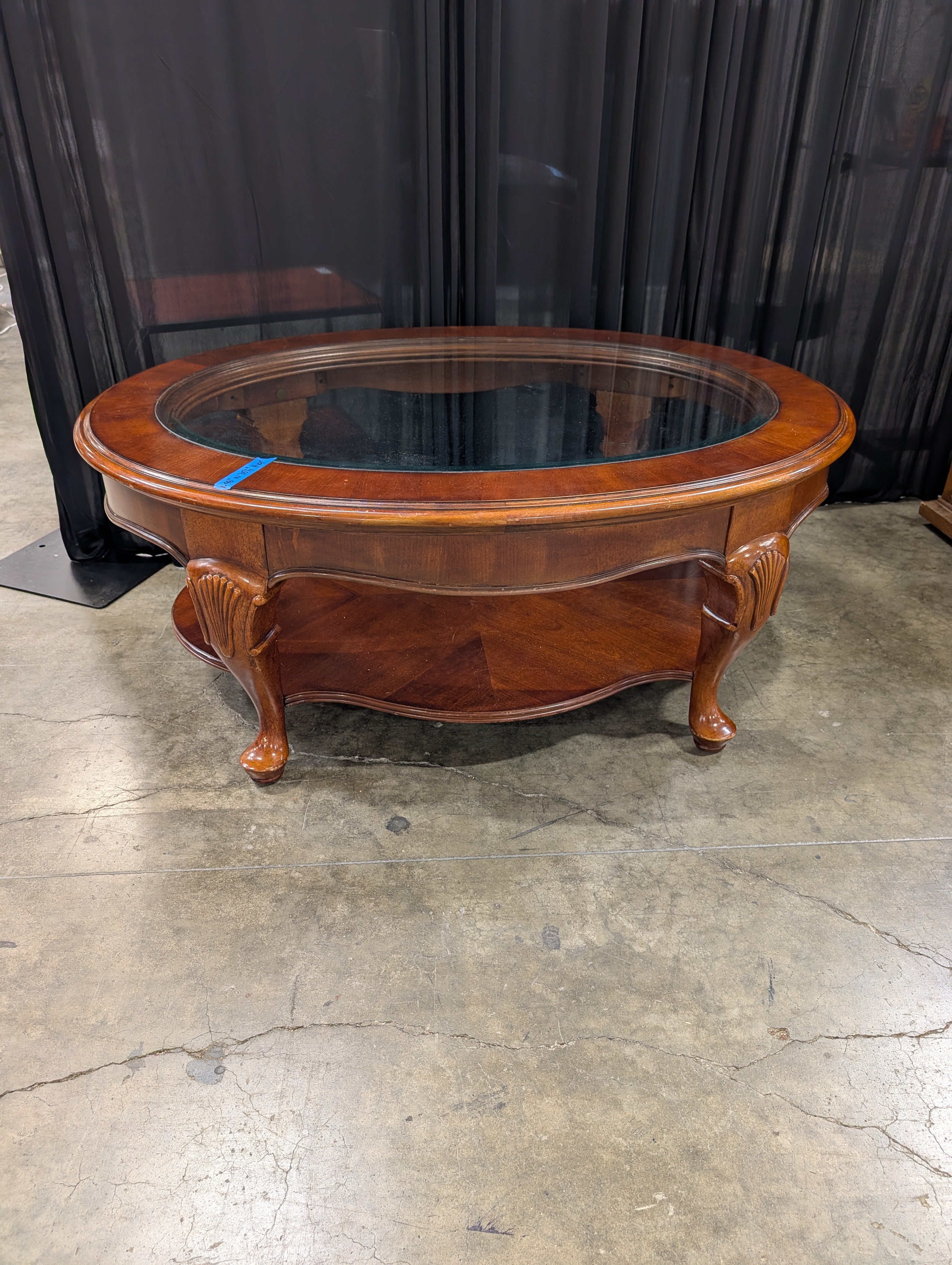 Traditional Reddish-Brown Oval Coffee Table with Glass Top