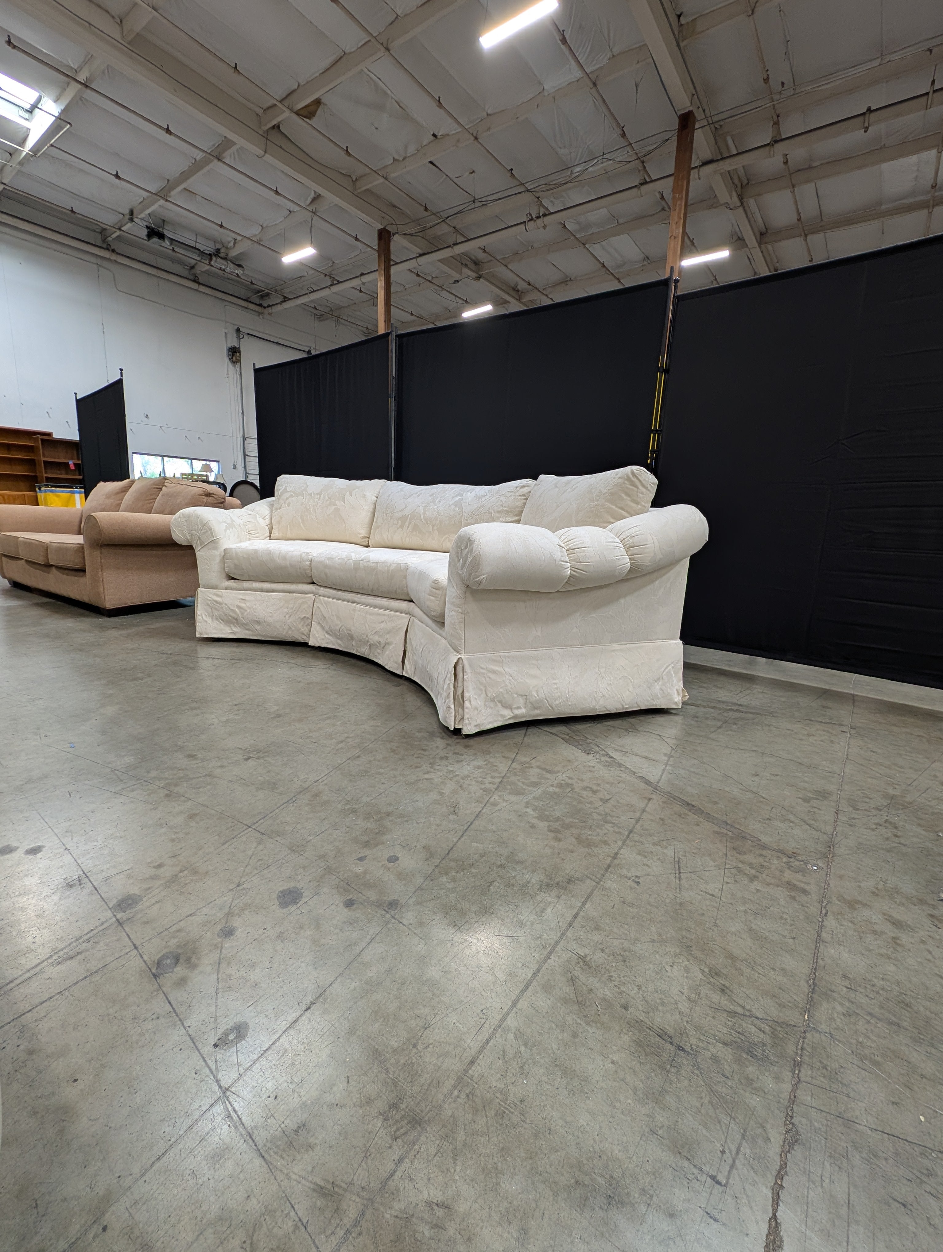 Has a stain Curved Cream Fabric Sectional Sofa with Rolled Arms