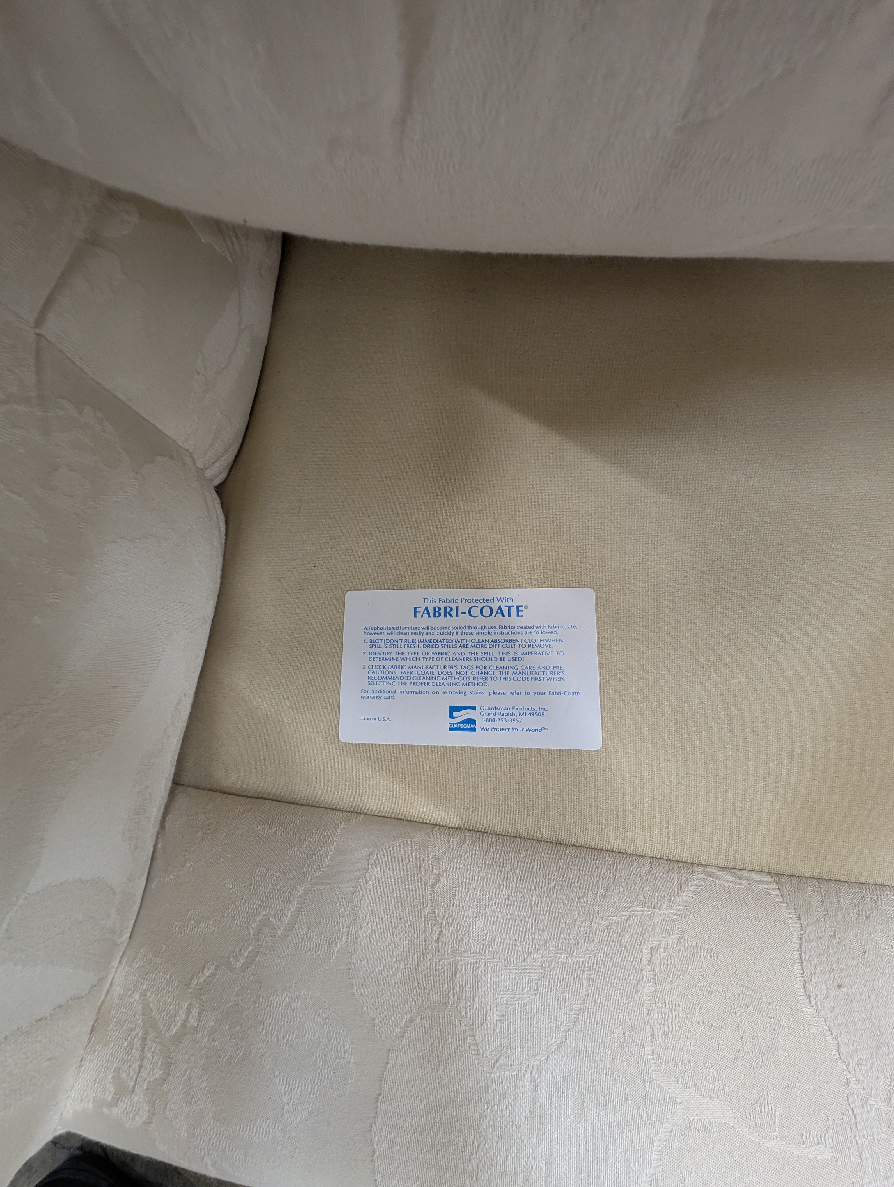 Has a stain Curved Cream Fabric Sectional Sofa with Rolled Arms