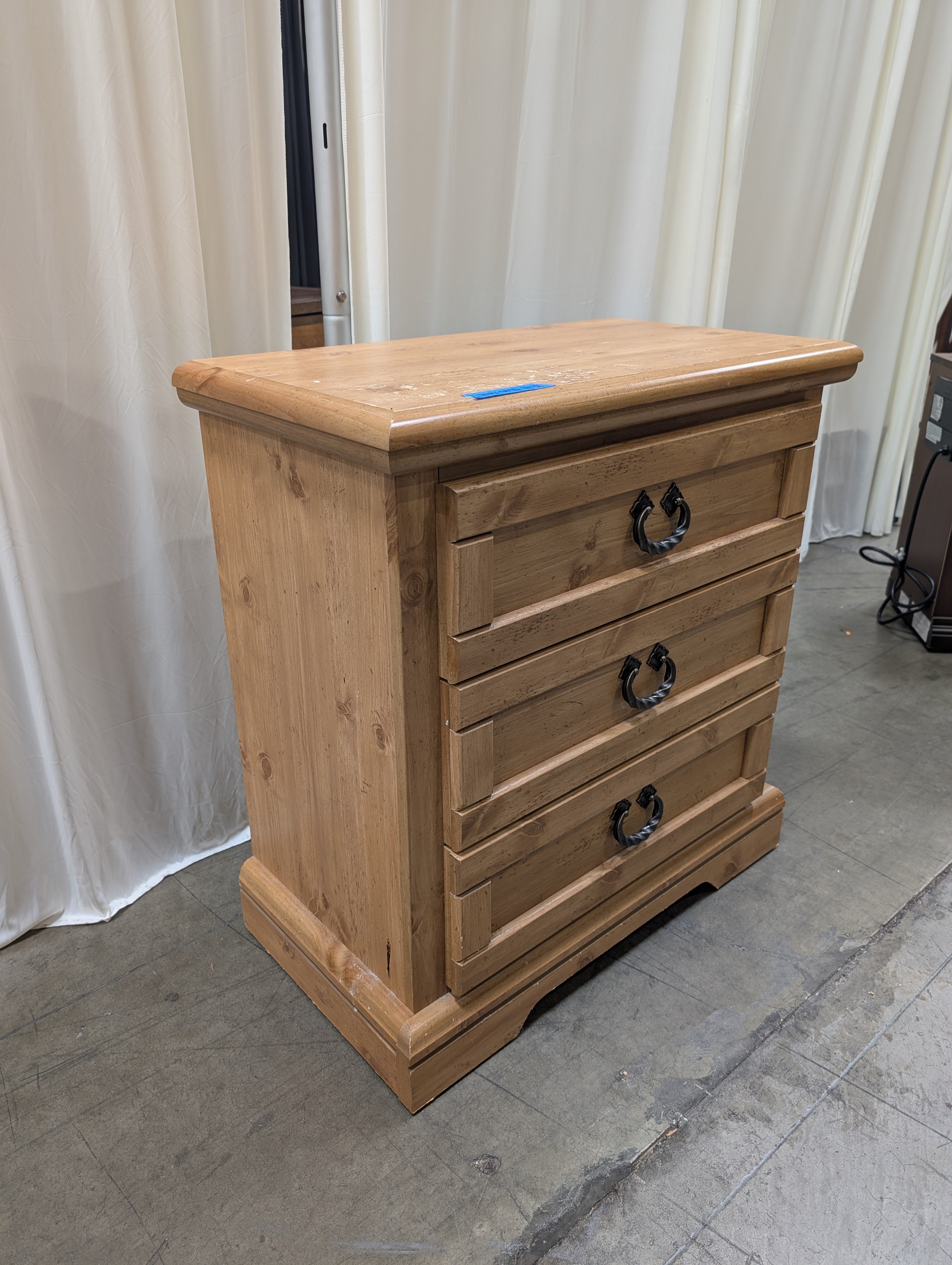 Light Wood Three-Drawer Nightstand with Metal Pulls