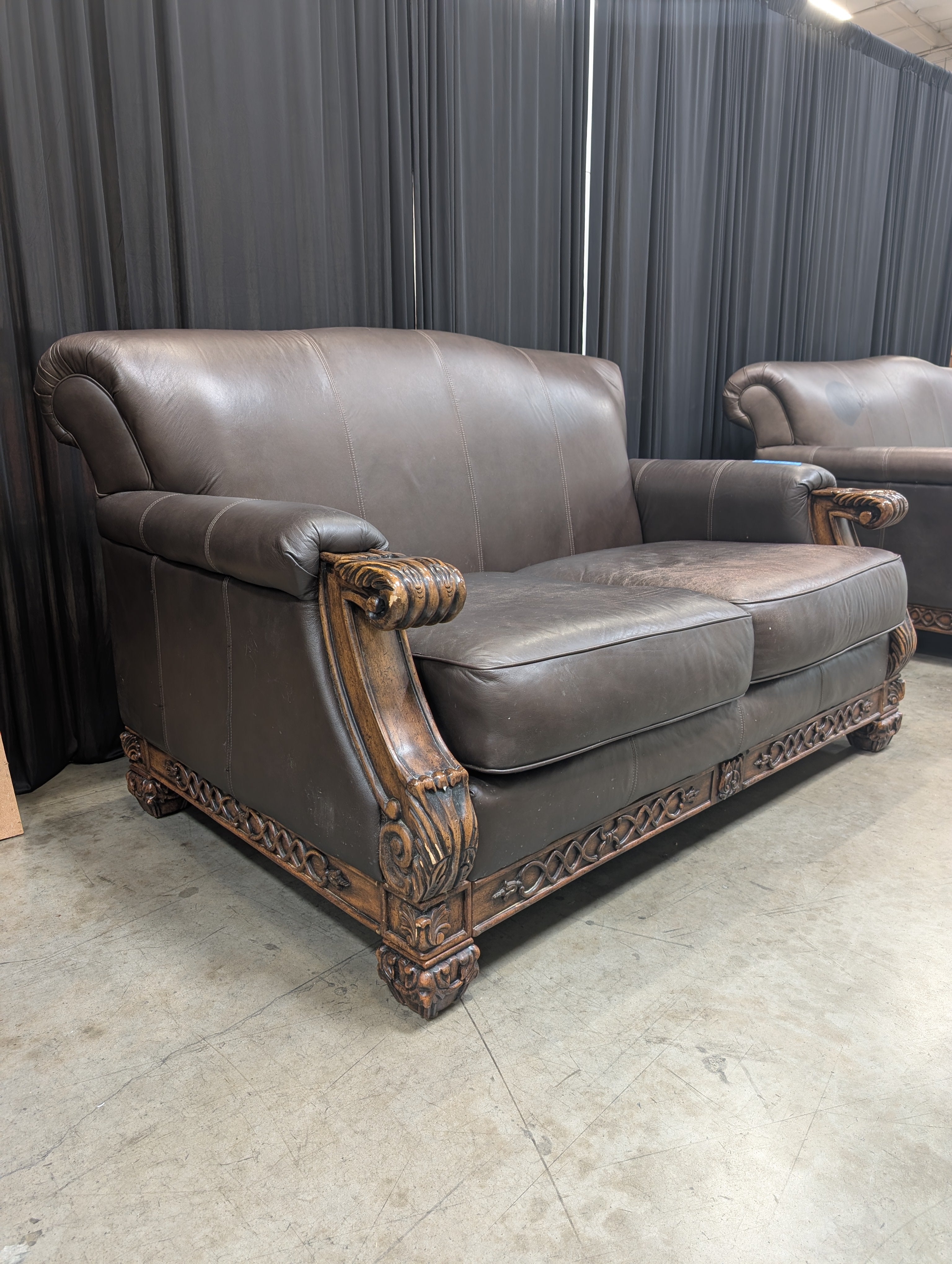 Traditional Brown Leather Loveseat with Carved Wood