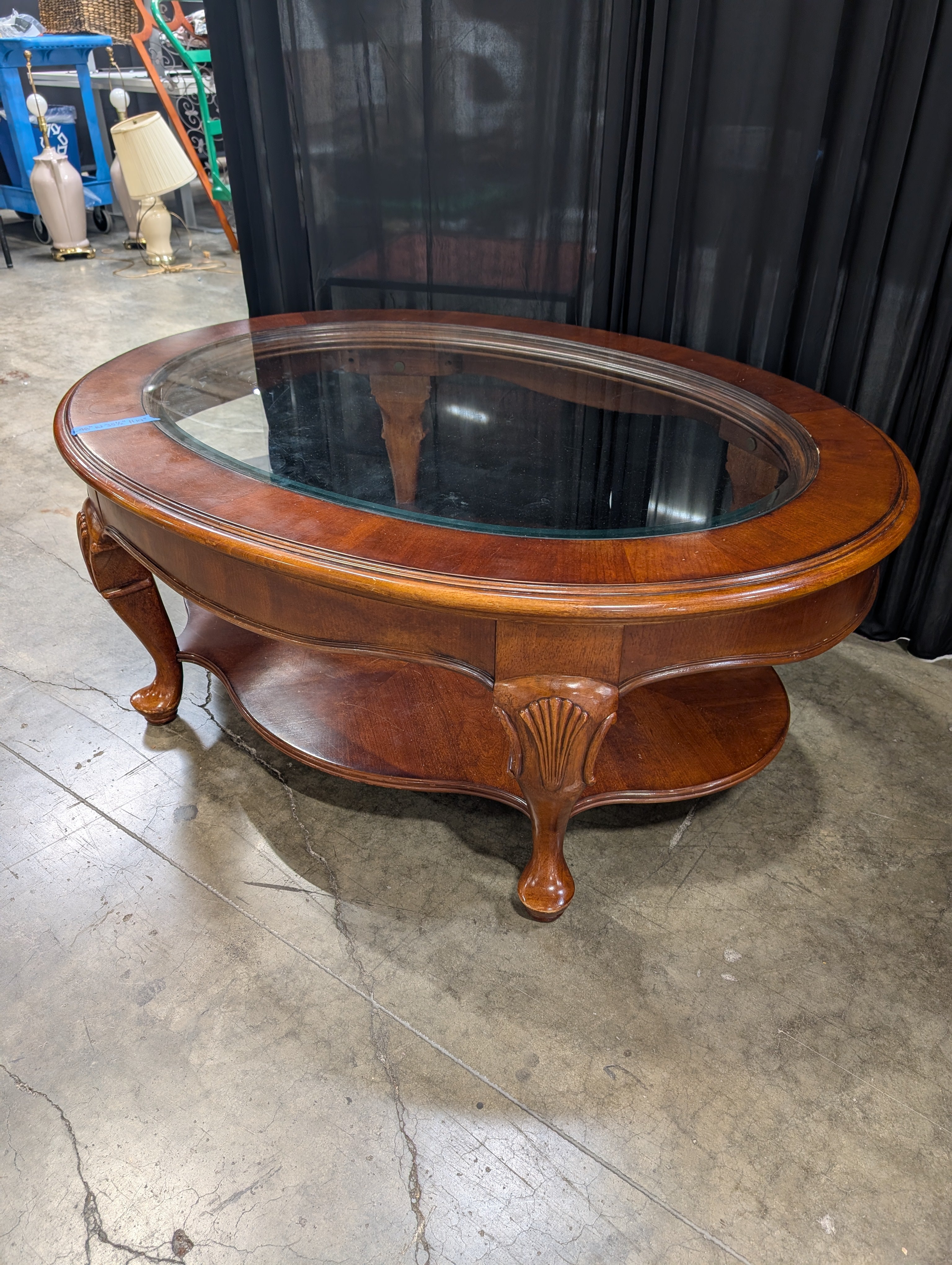 Traditional Reddish-Brown Oval Coffee Table with Glass Top